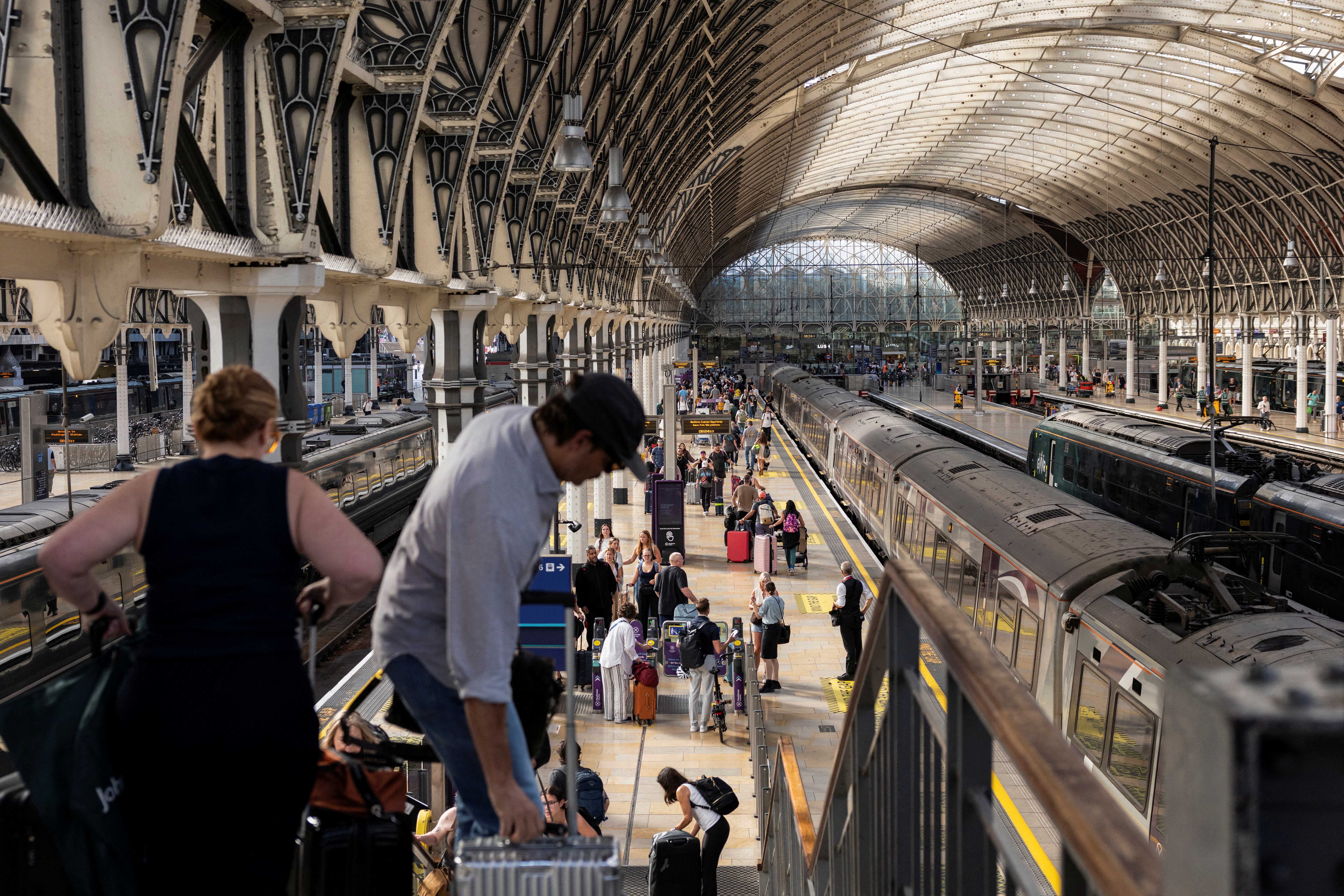 Passengers make their way through Paddington train station in central London (AFP/Getty)