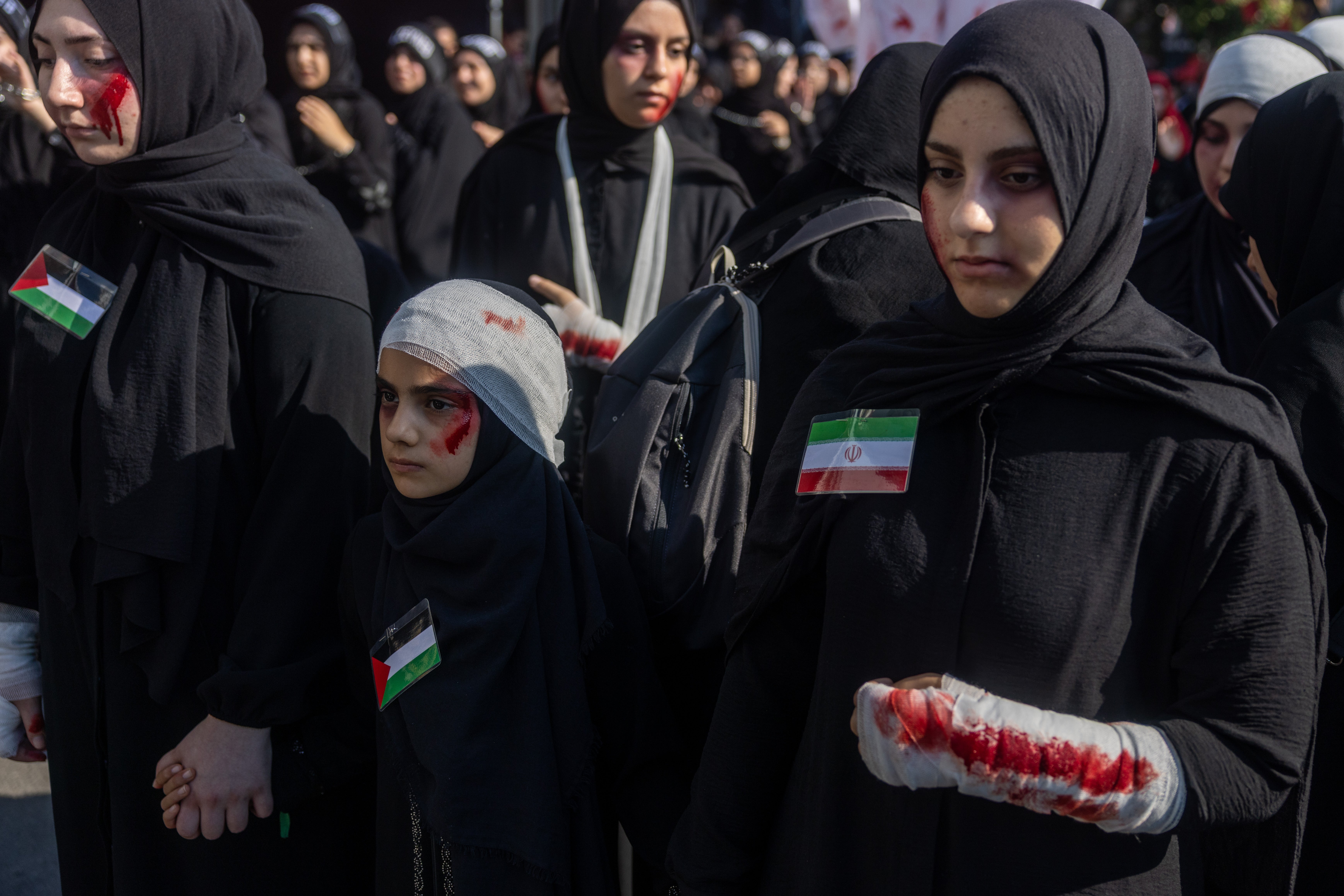 Women with simulated wounds symbolising war victims take part in a mourning procession marking Ashura, the holiest day on the Shi’ite Muslim calendar on June 25, 2026 in Istanbul