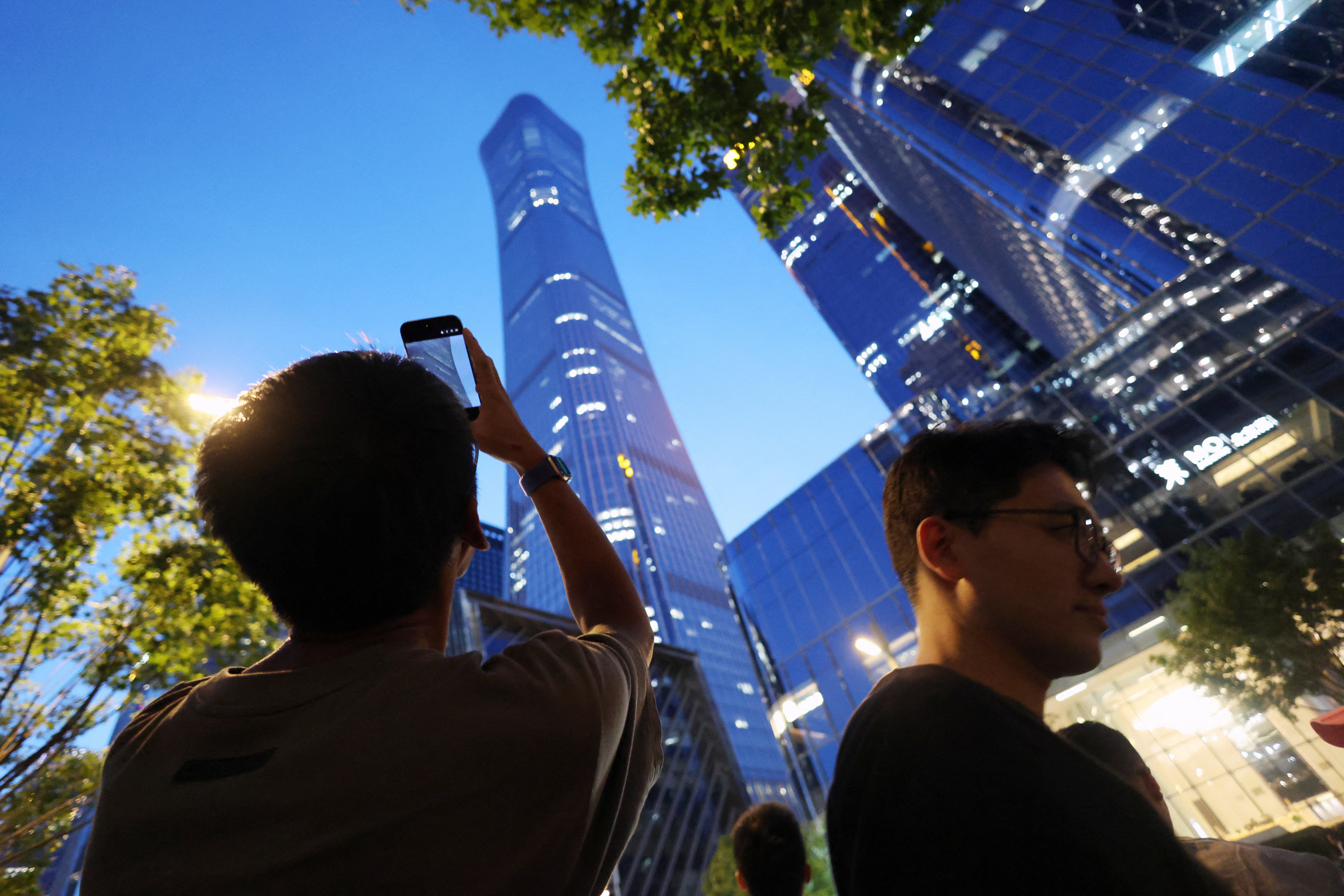 Police prevented some people from taking pictures and asked others to delete those they had taken while ushering people away from the CITIC Tower in Beijing