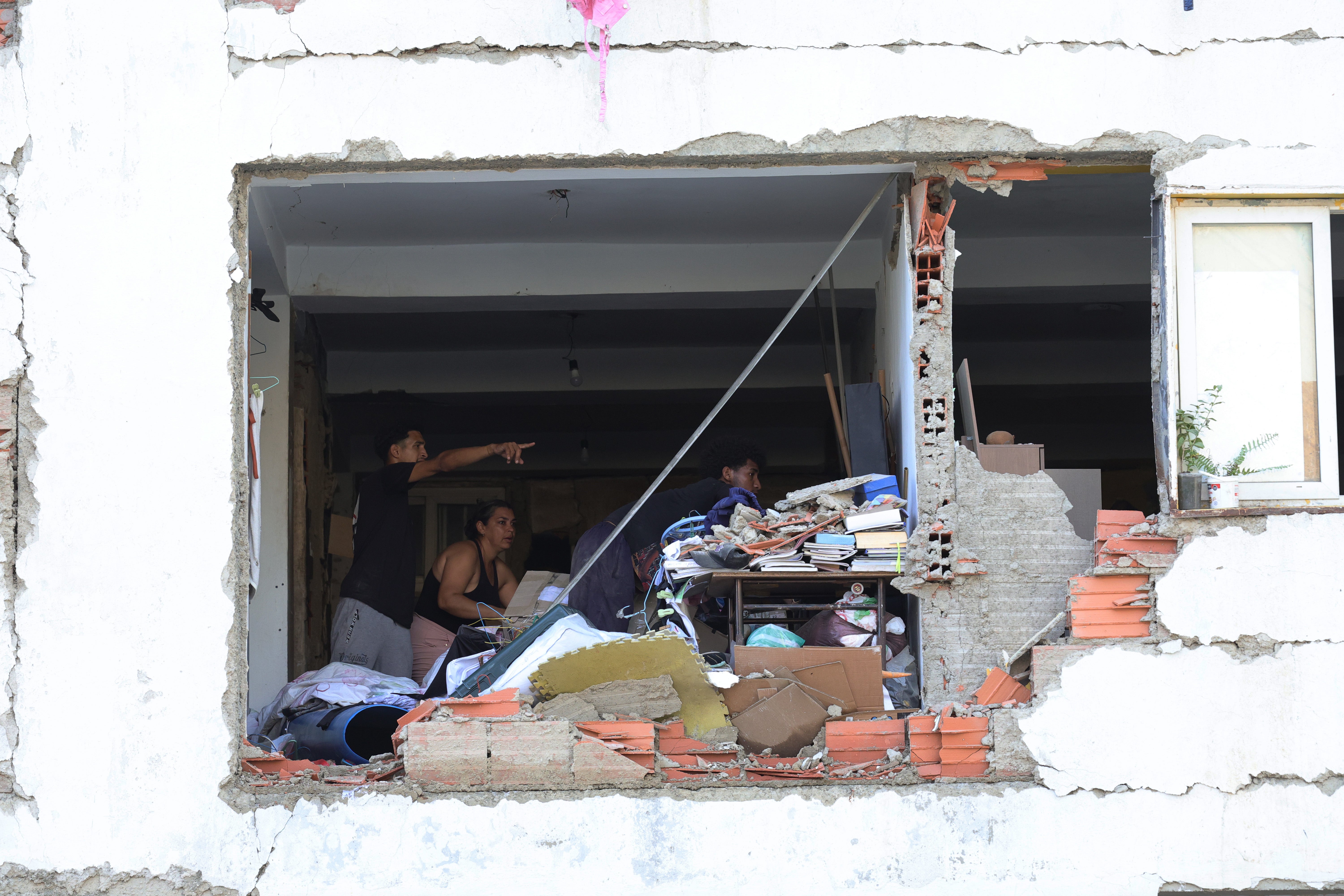 A person searches for victims amid debris (Getty Images)
