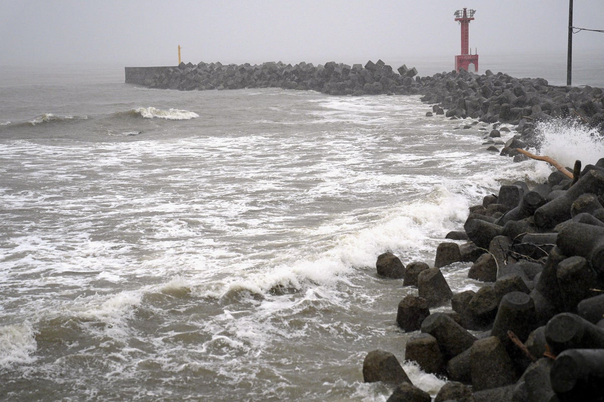 Two tropical storms pound Japan, causing flooding and landslides