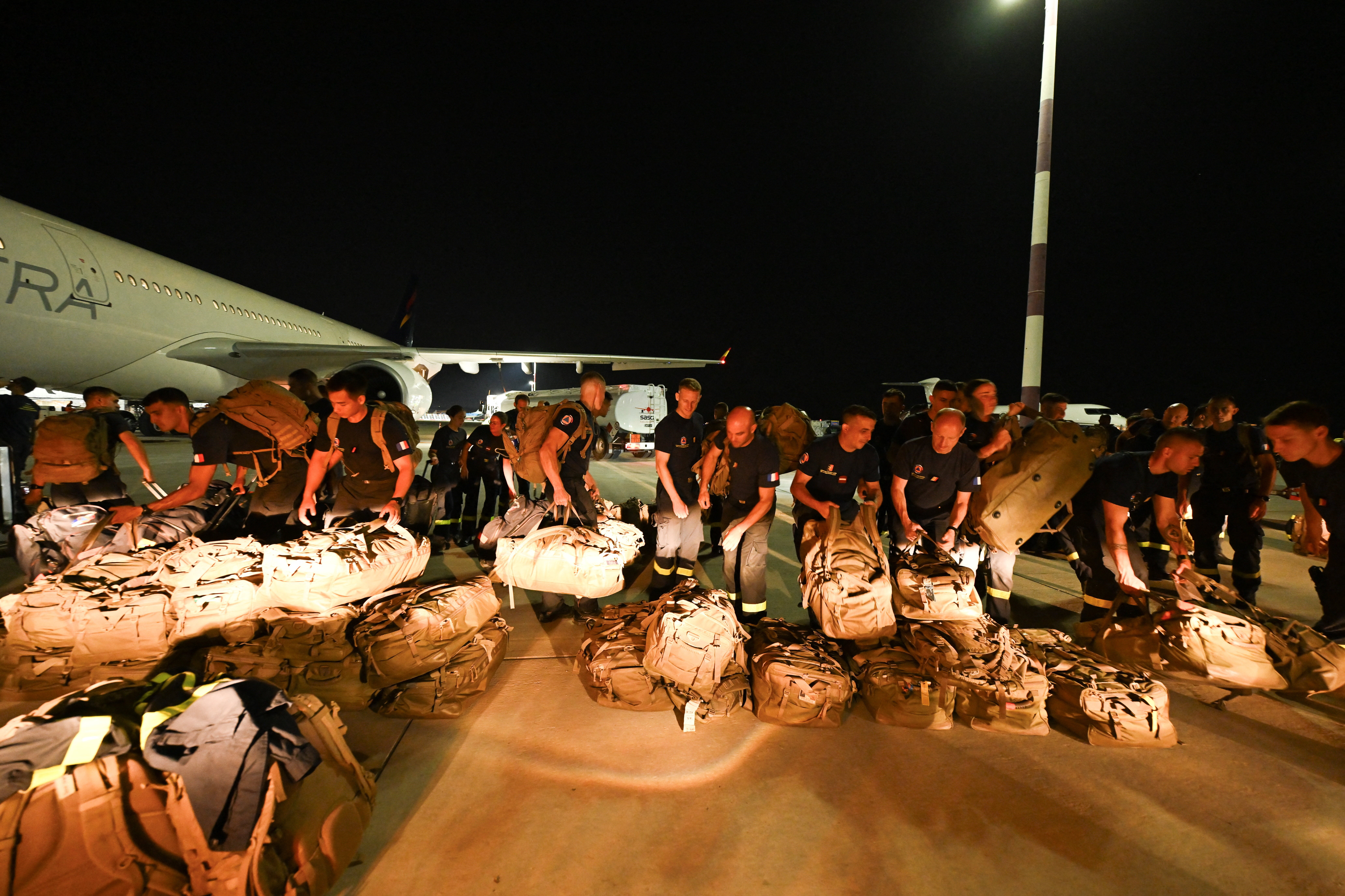 French officers of the 7th Civil Security Training and Response Regiment prepare their shipment before flying to Venezuela to provide help, at the Marseille Provence airport in Marignane, southern France, on 27 June 2026