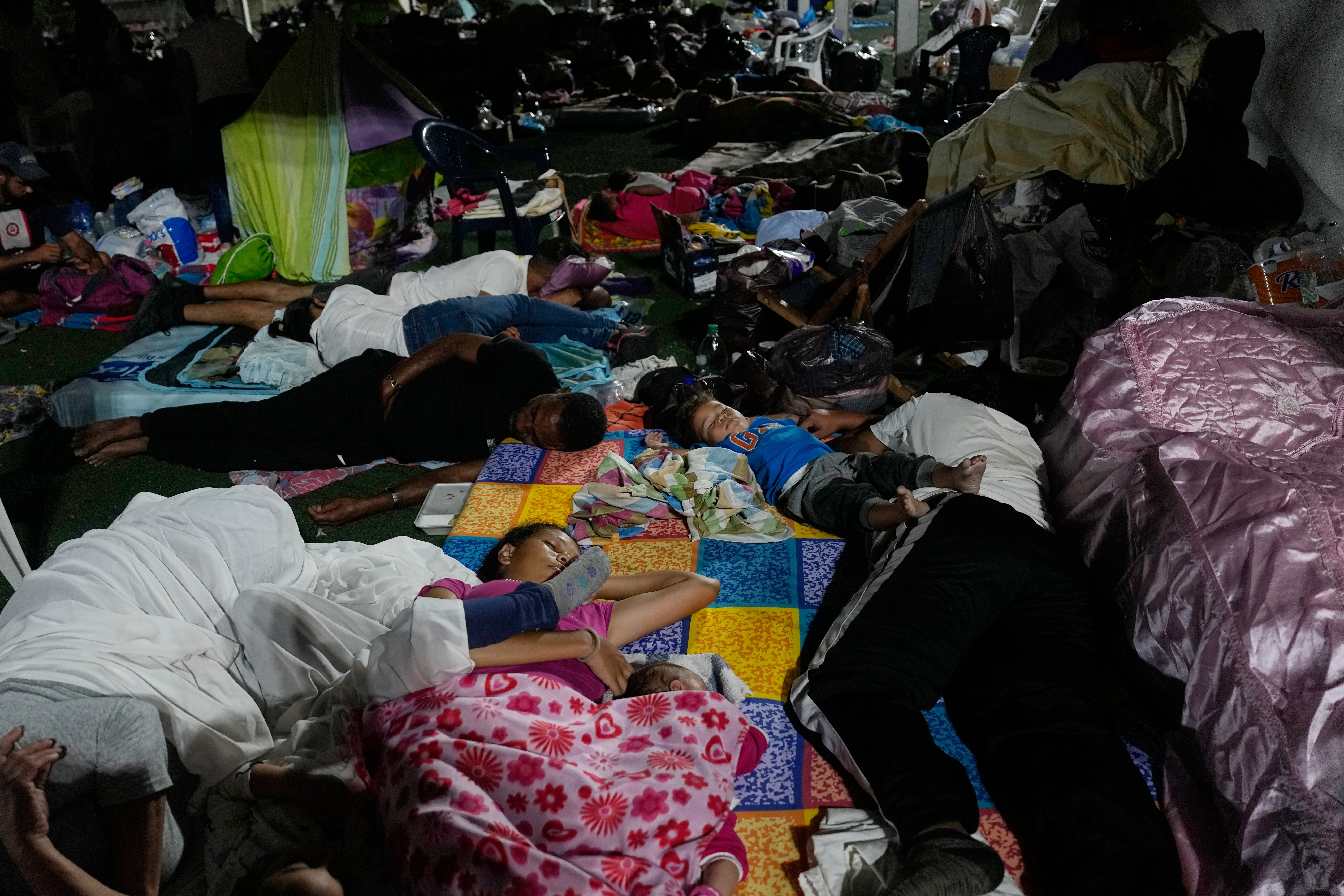 People whose homes were destroyed sleep at a sports complex serving as a shelter three days after earthquakes struck La Guaira, Venezuela, Saturday, 27 June, 2026