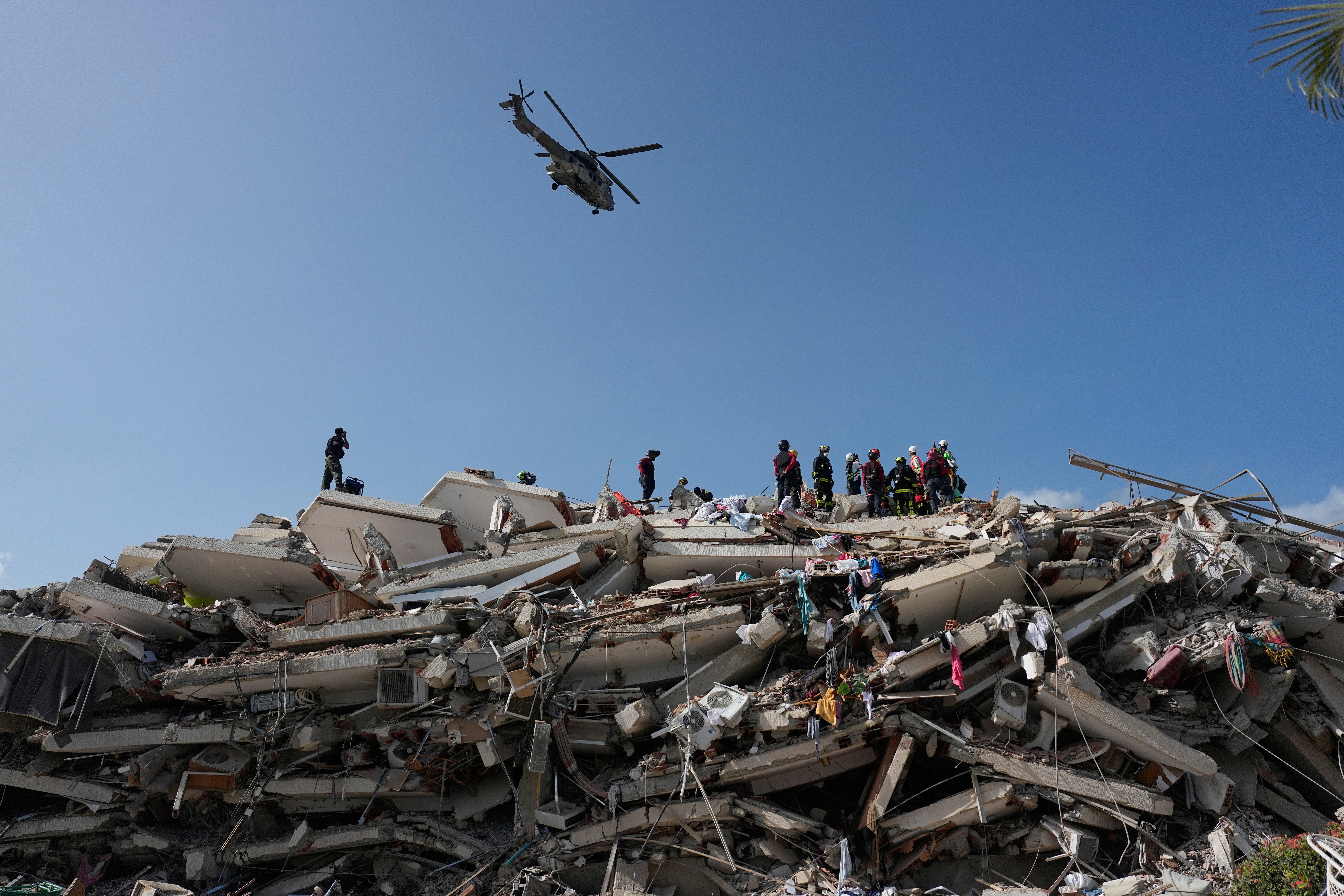 Rescue workers search through the rubble three days after earthquakes struck Catia La Mar
