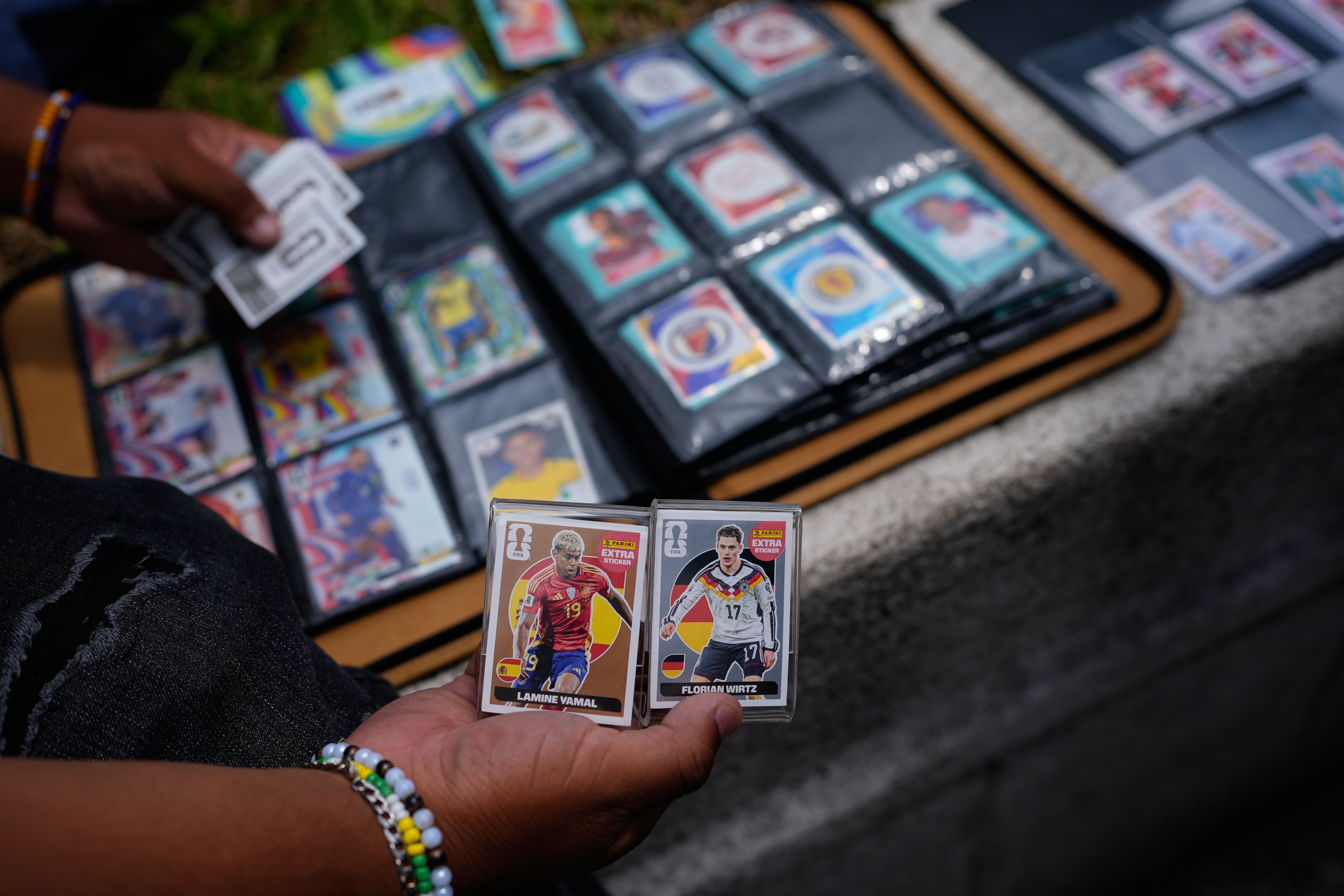 Youth exchange Panini World Cup stickers in Mexico City, Tuesday, June 16, 2026. (AP Photo/Marco Ugarte)