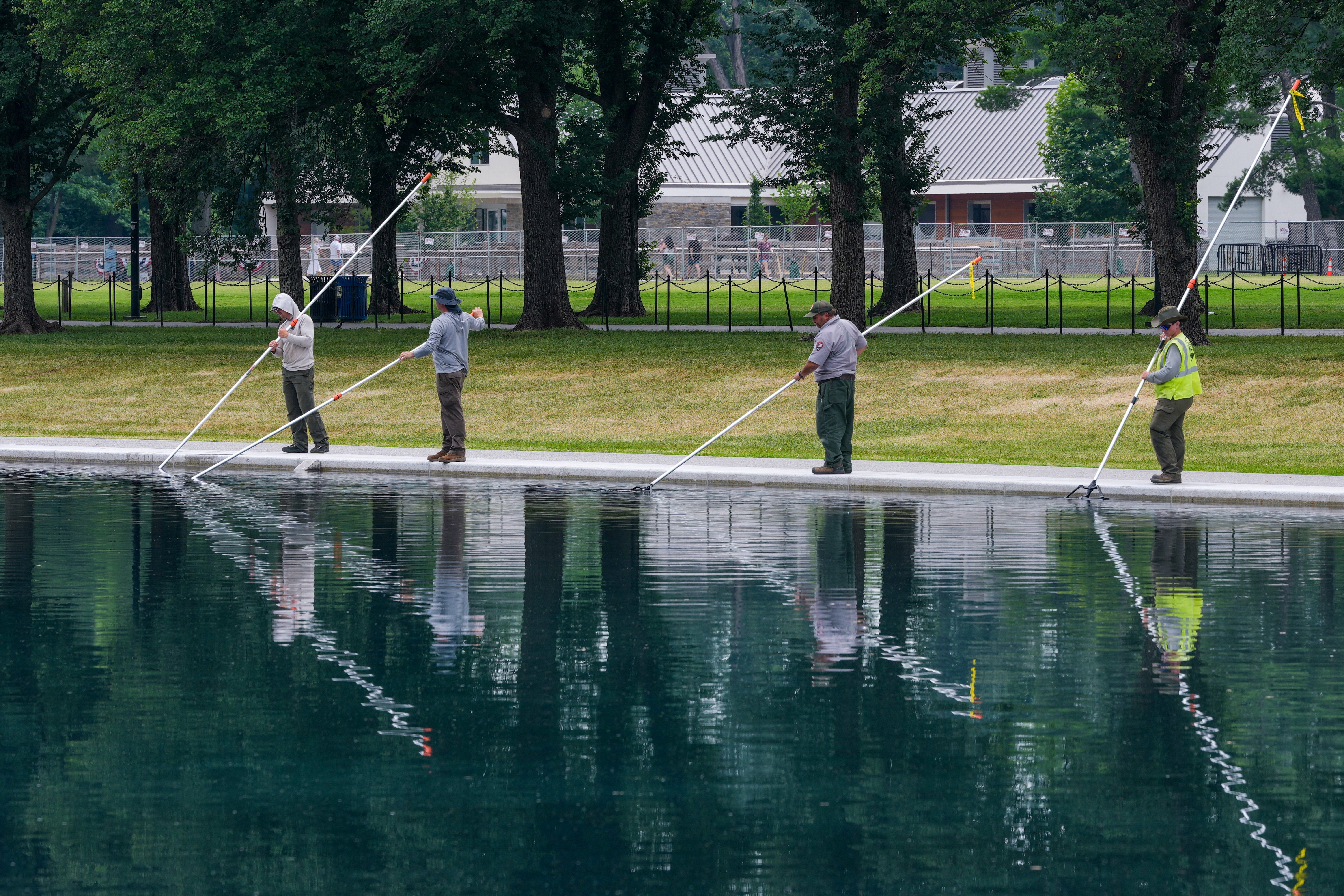 Workers clean algae from the Lincoln Memorial Reflecting Pool following the completion of recent renovations in Washington, D.C, June 26