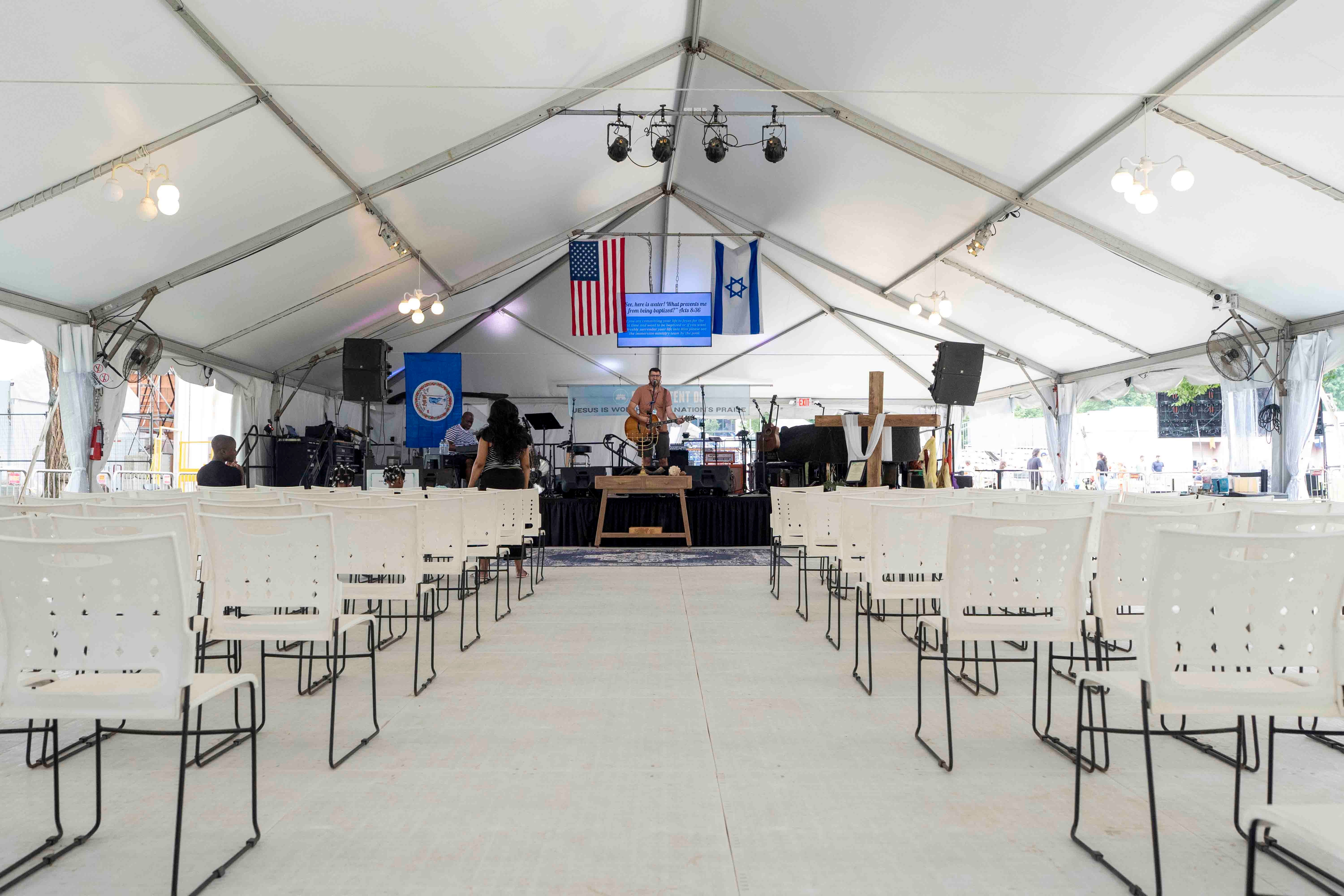 Jason Hershey, founder of David’s Tent, performs for what appears to be just two people Saturday at the Great American State Fair worship space