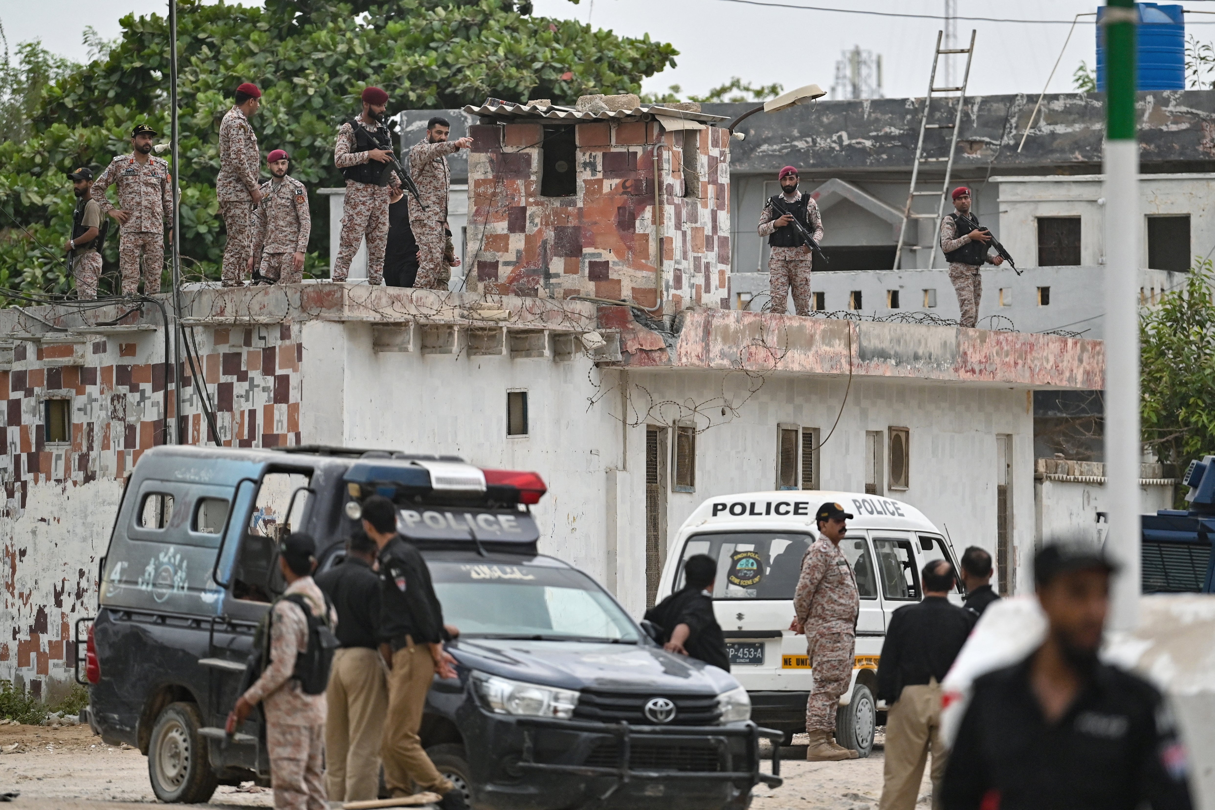 Security personnel inspect the rooftop of a compound at the end of a clearance operation following a militant attack in Karachi on 28 June 2026