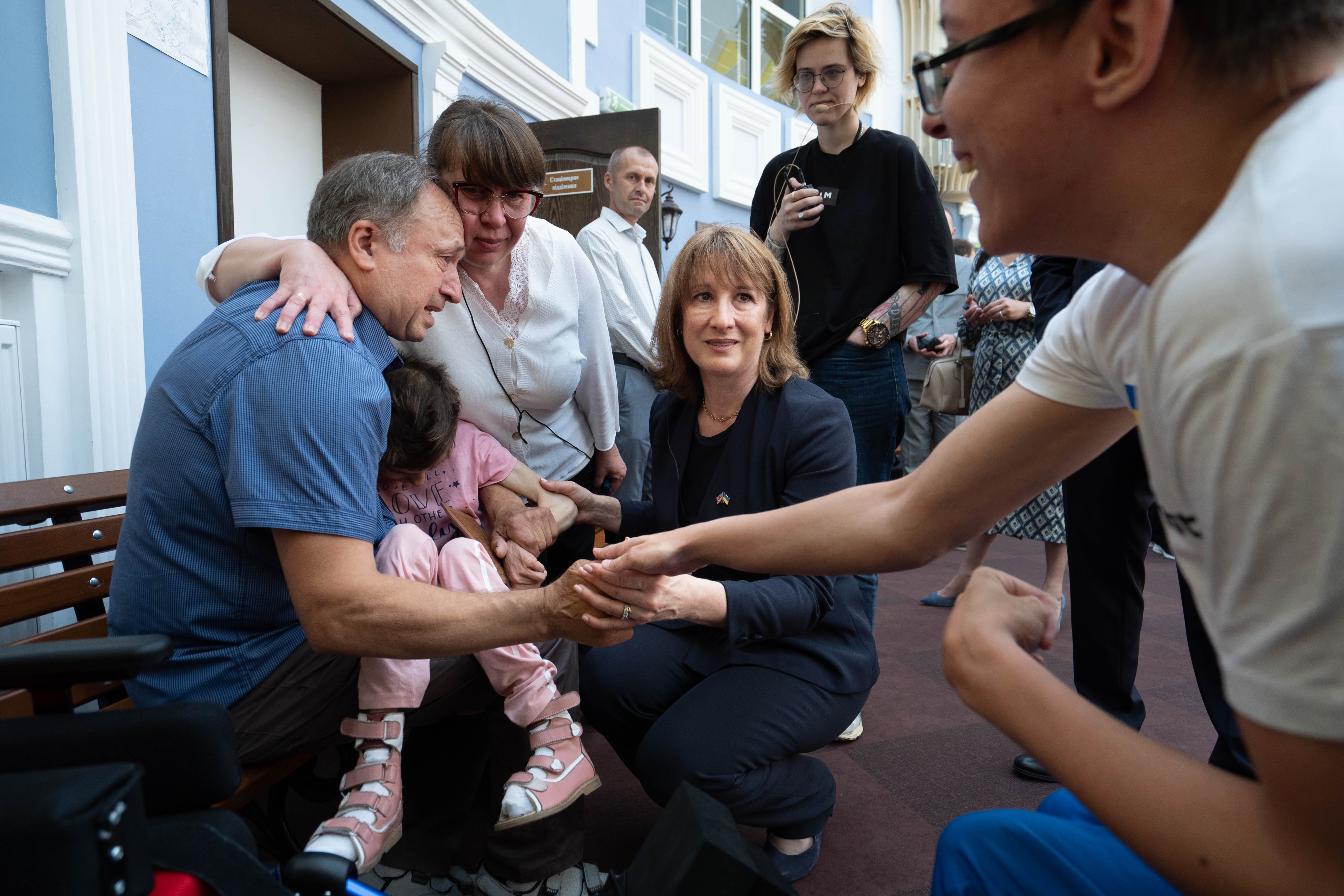 Rachel Reeves meets a family who are being supported by a social service delivery centre with UK backing (PA)