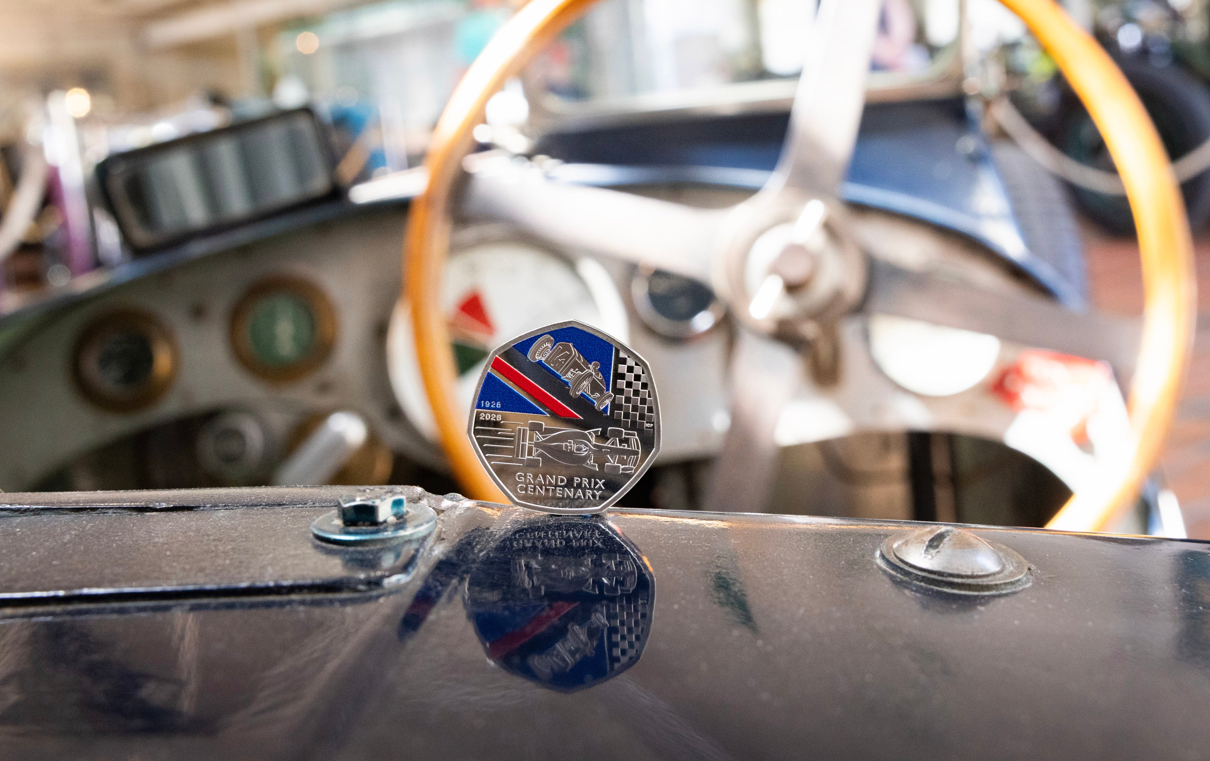 The coin was unveiled at Brooklands in Weybridge, Surrey, home of Britain's first Grand Prix in August 1926, and was photographed next to a Delage car.