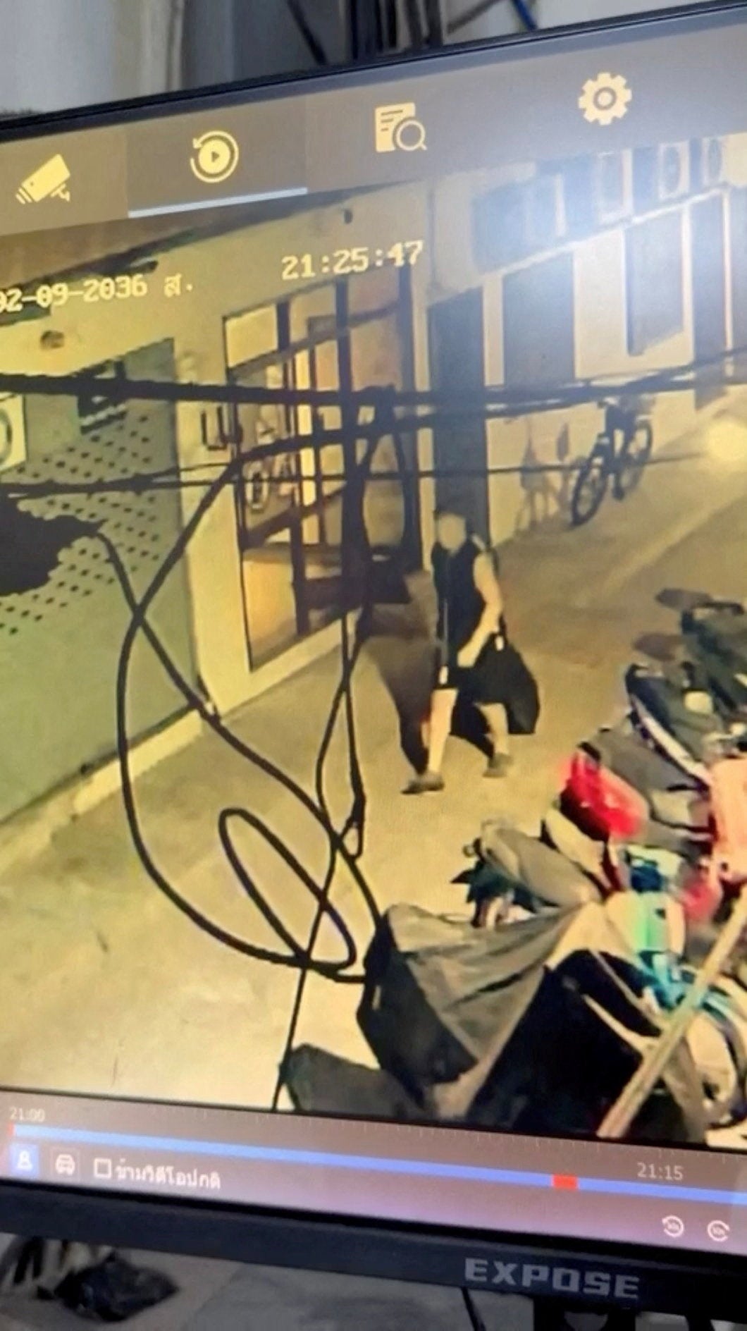 Simon Peter Carman walks with a suitcase outside a condominium, in Pattaya City, Thailand, in this screengrab obtained from a handout video released on 27 June 2026 (Pattaya Provincial Police Station)