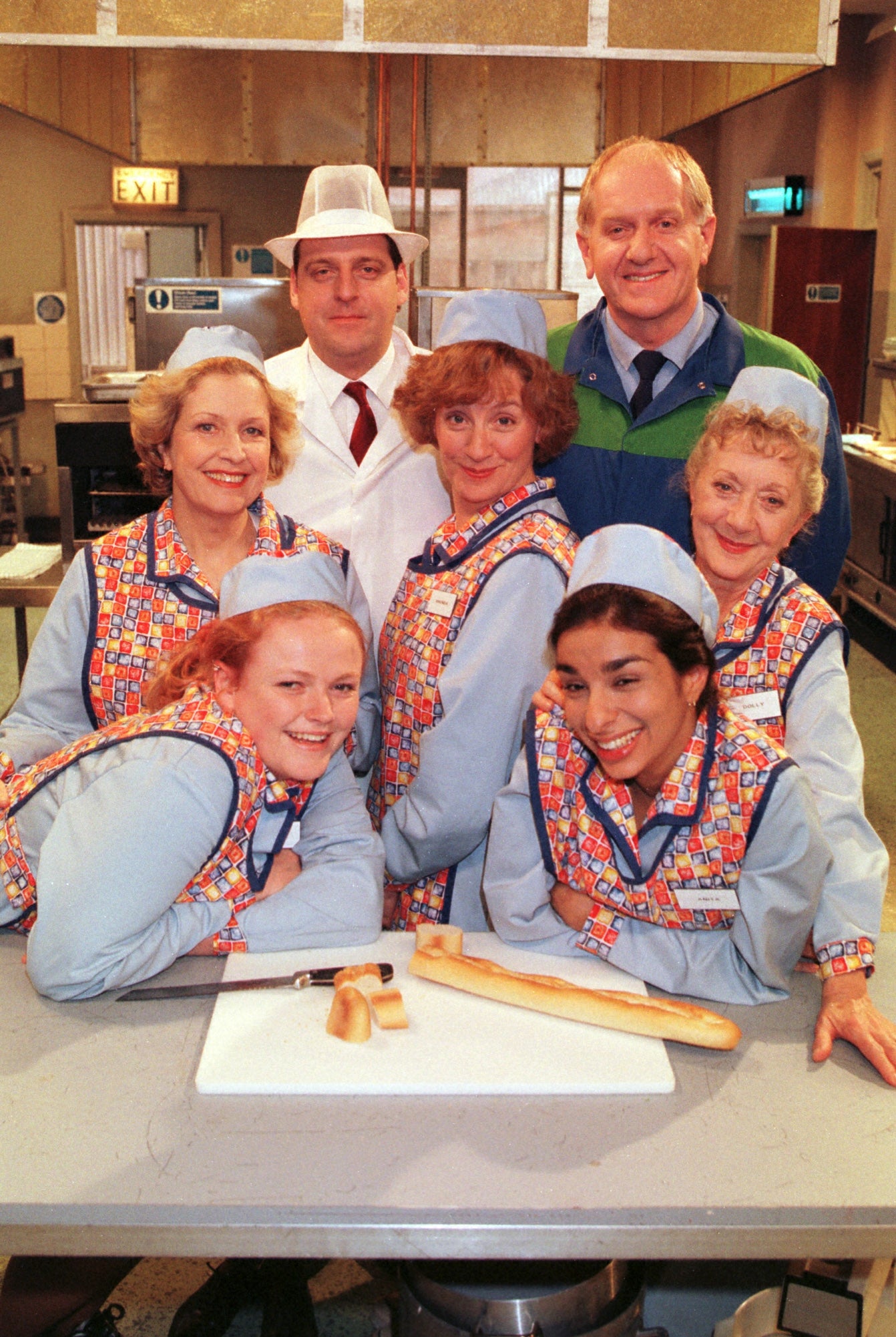 Dinnerladies (l to r) Andrew Dun as Tony the manager, Duncan Preston as Stan the DIY man, Maxine Peake as Twinkle, Anne Reid as Jean, Victoria Wood as Bren, Thelma Barlow as Dolly and Shobna Gulatias as Anita