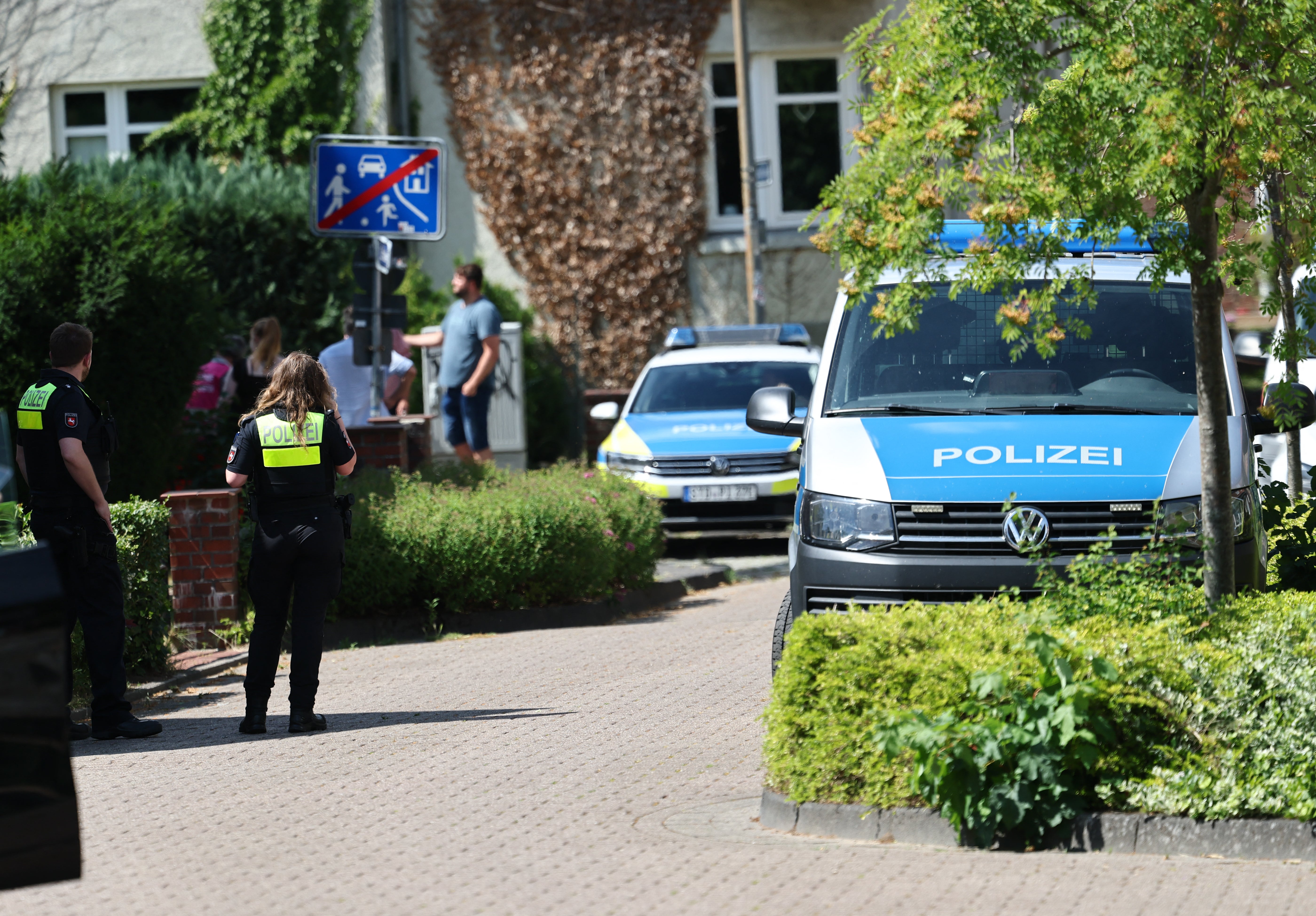 Police stand near the scene where five people were killed in a shooting in Stade