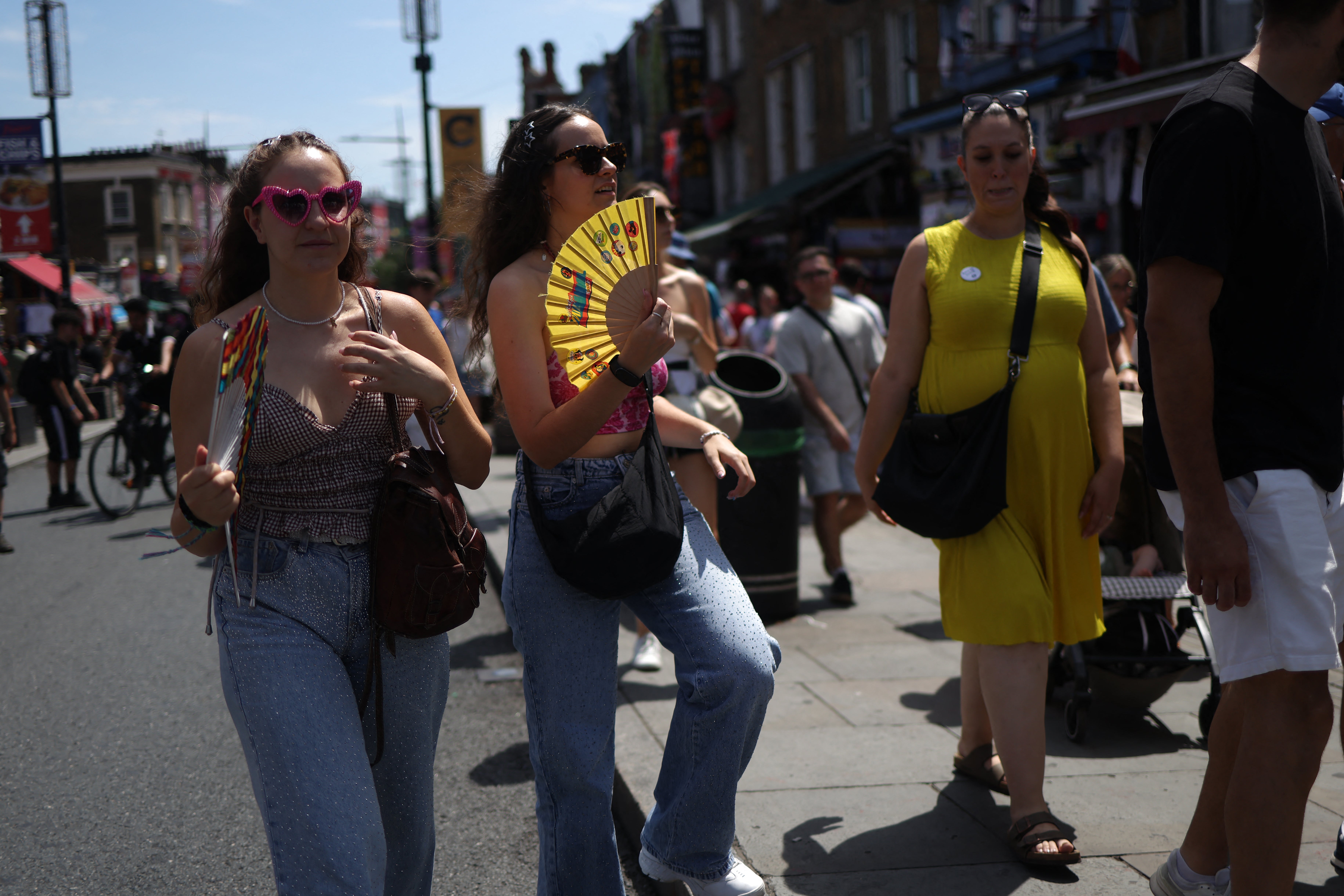 Shoppers take advantage of fans as they visit Camden in central London on Saturday