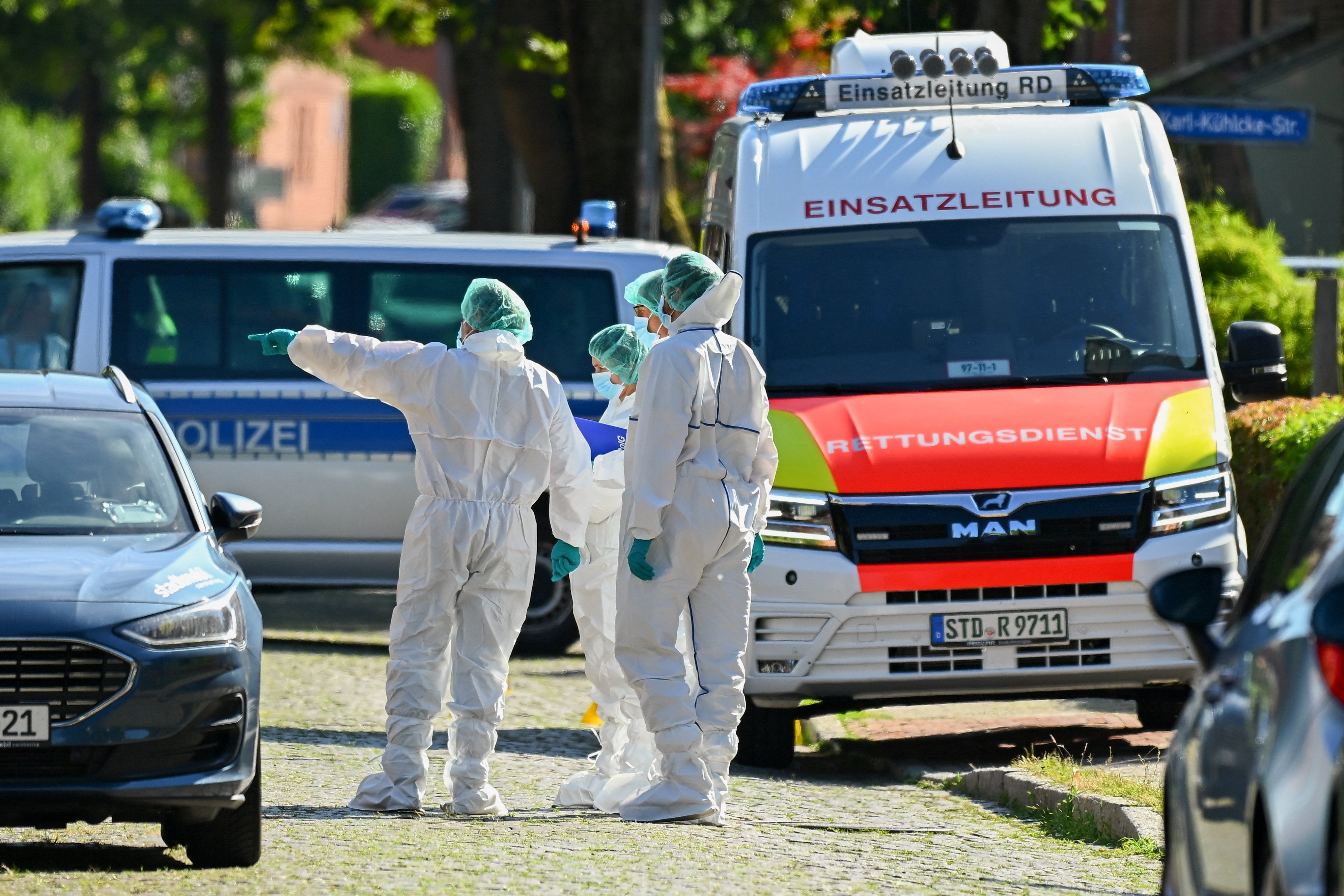 Forensic experts work at the scene (Reuters)