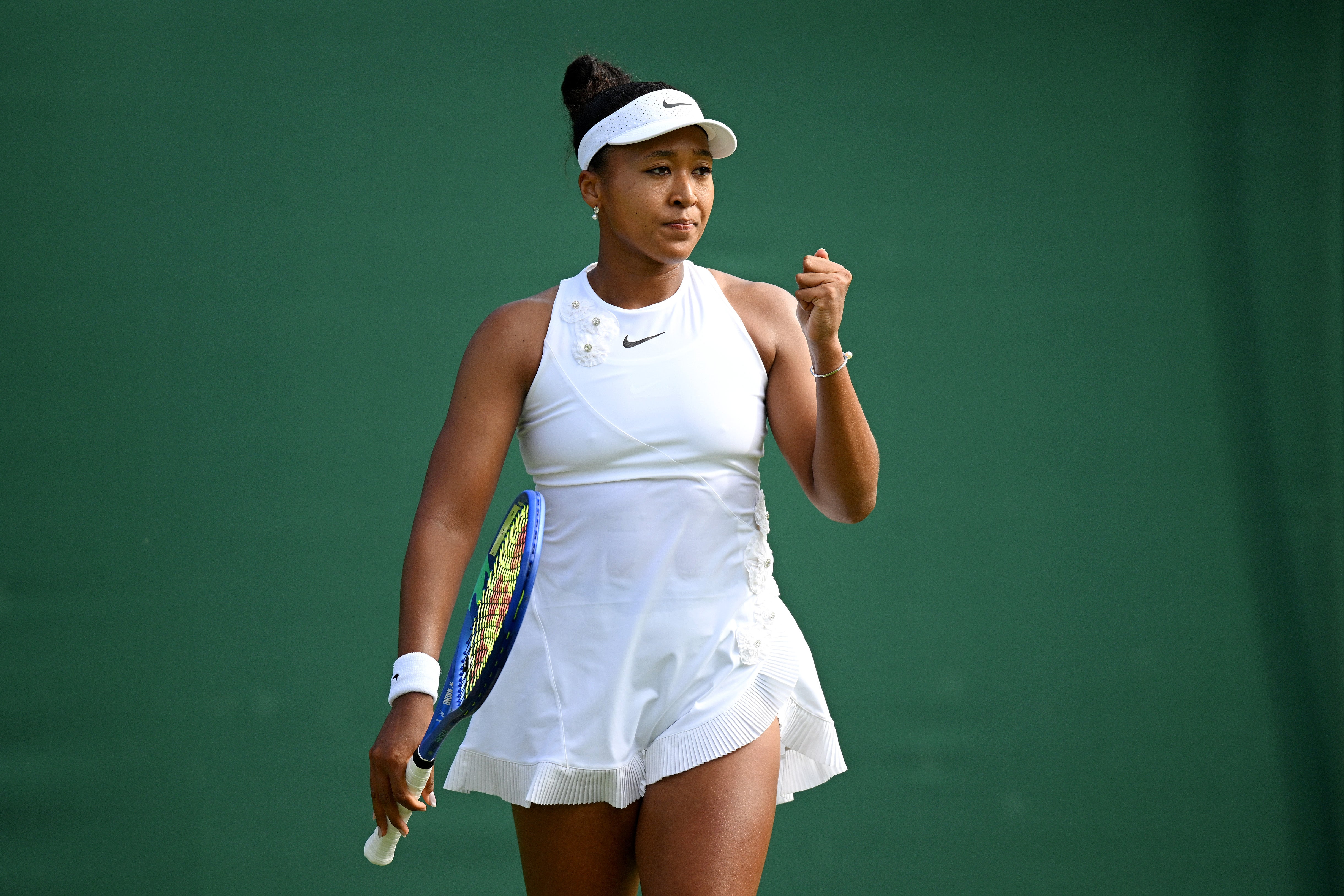 Osaka wore a white dress underneath her walk-on outfit