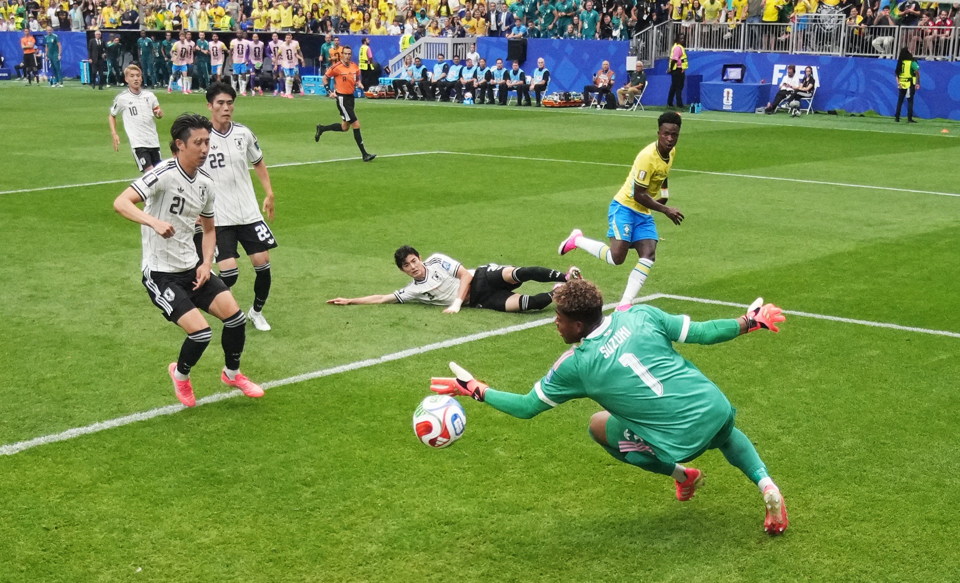 Japan's Zion Suzuki saves a shot from Brazil's Vinicius Junior (Reuters)