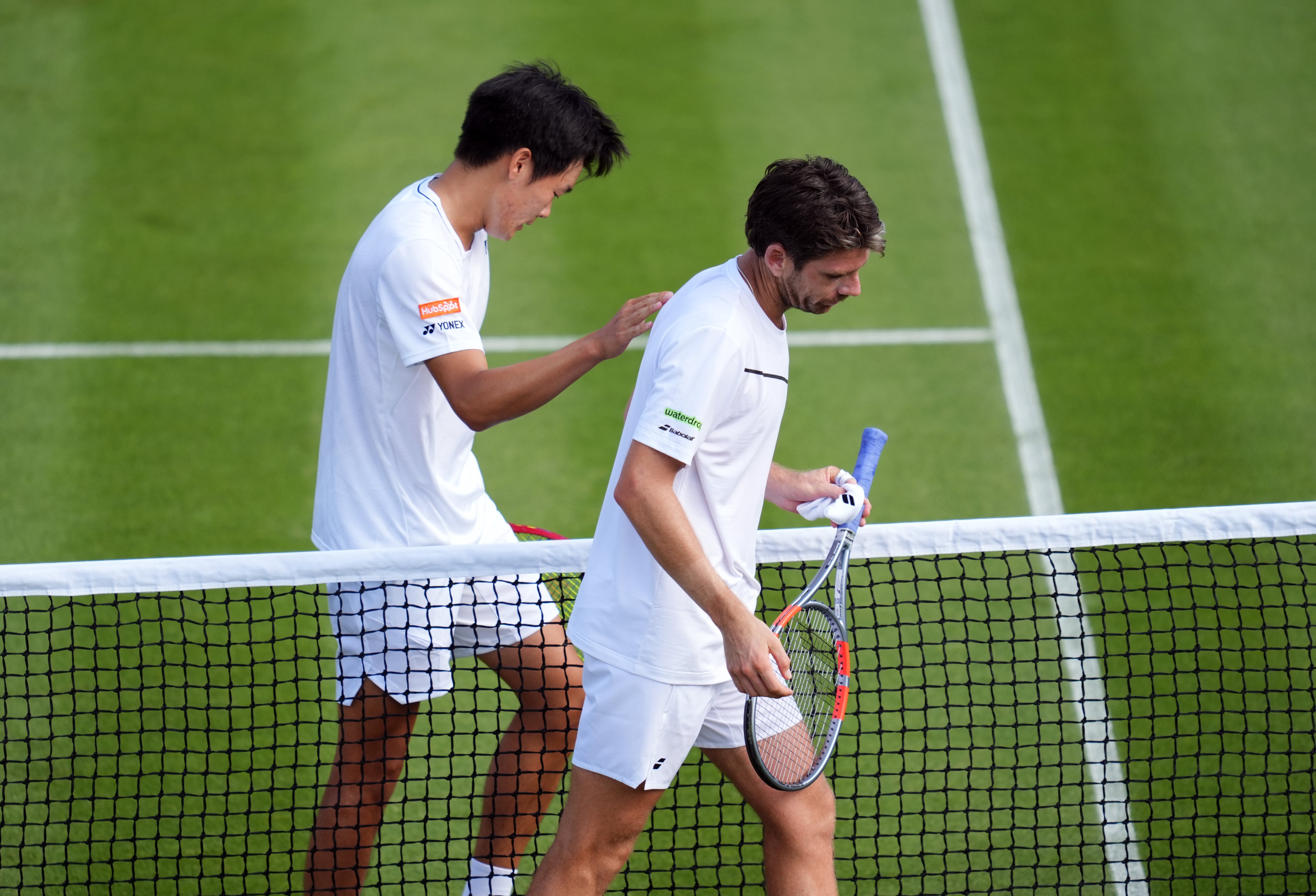 Michael Zheng gives Cameron Norrie a consoling pat (Adam Davy/PA) (PA Wire)