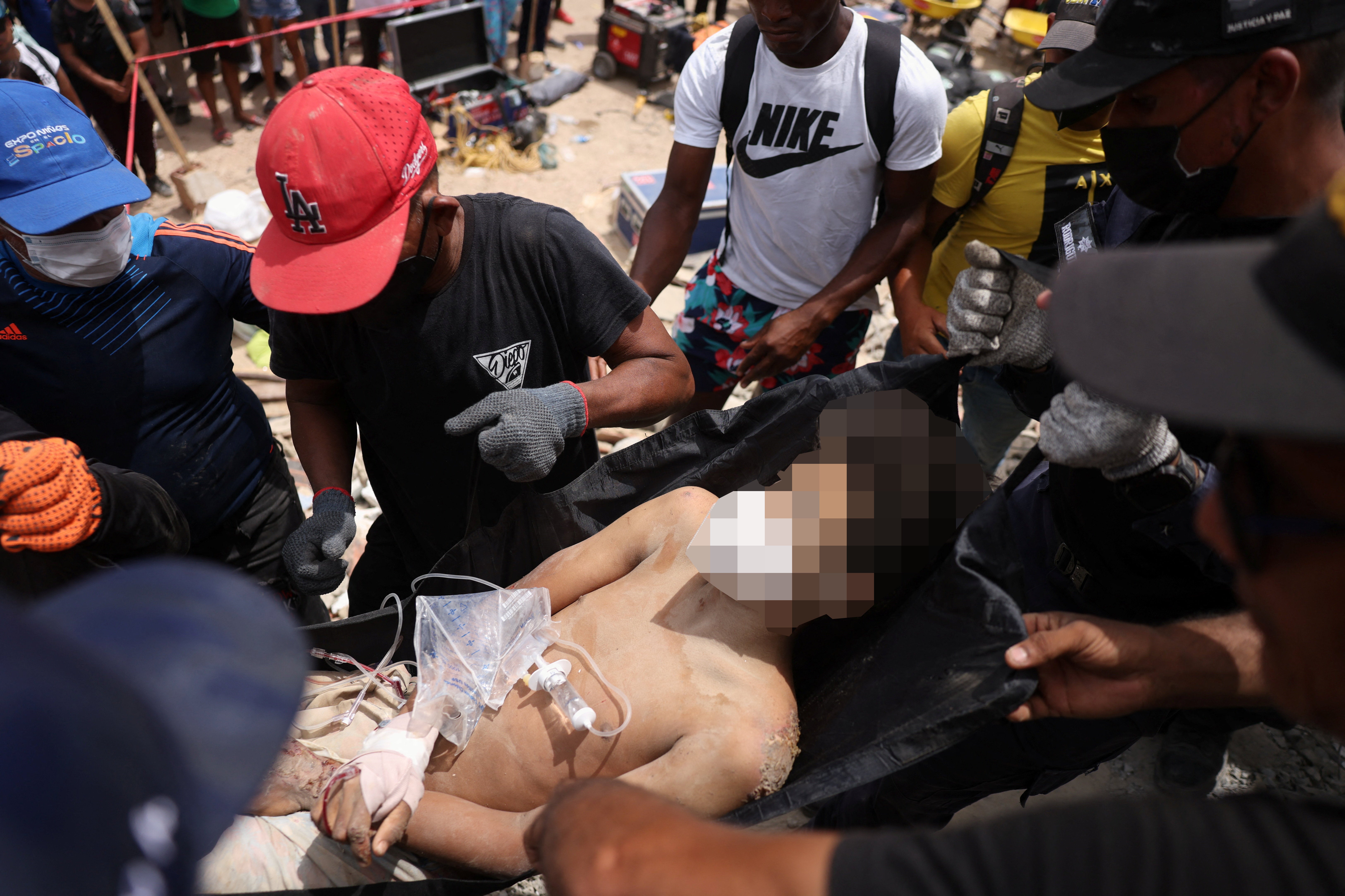 A person who was trapped under the rubble of a building is carried, after earthquakes hit the country, in La Guaira, Venezuela (Reuters)