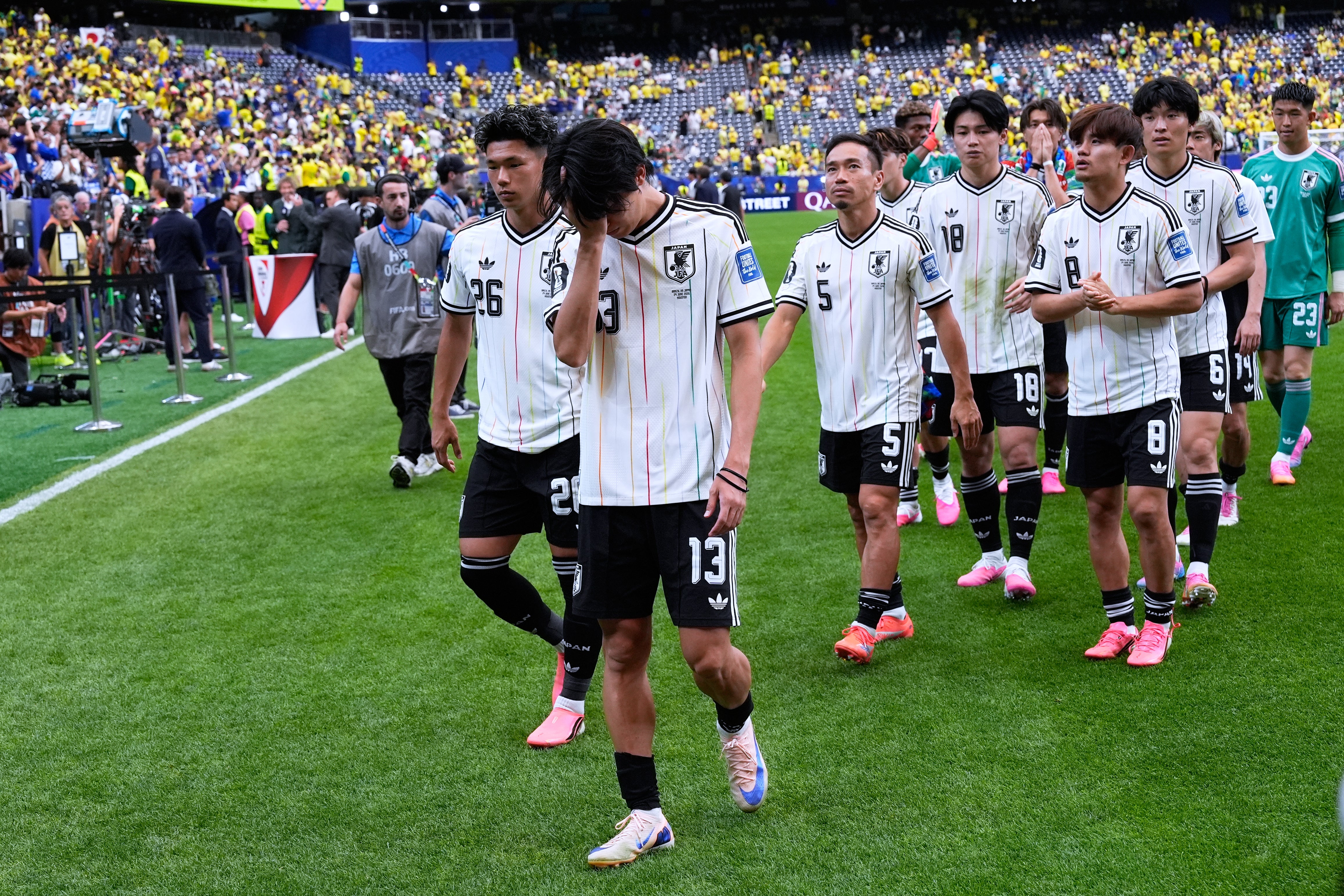 A disappointed Japan team leaves the field