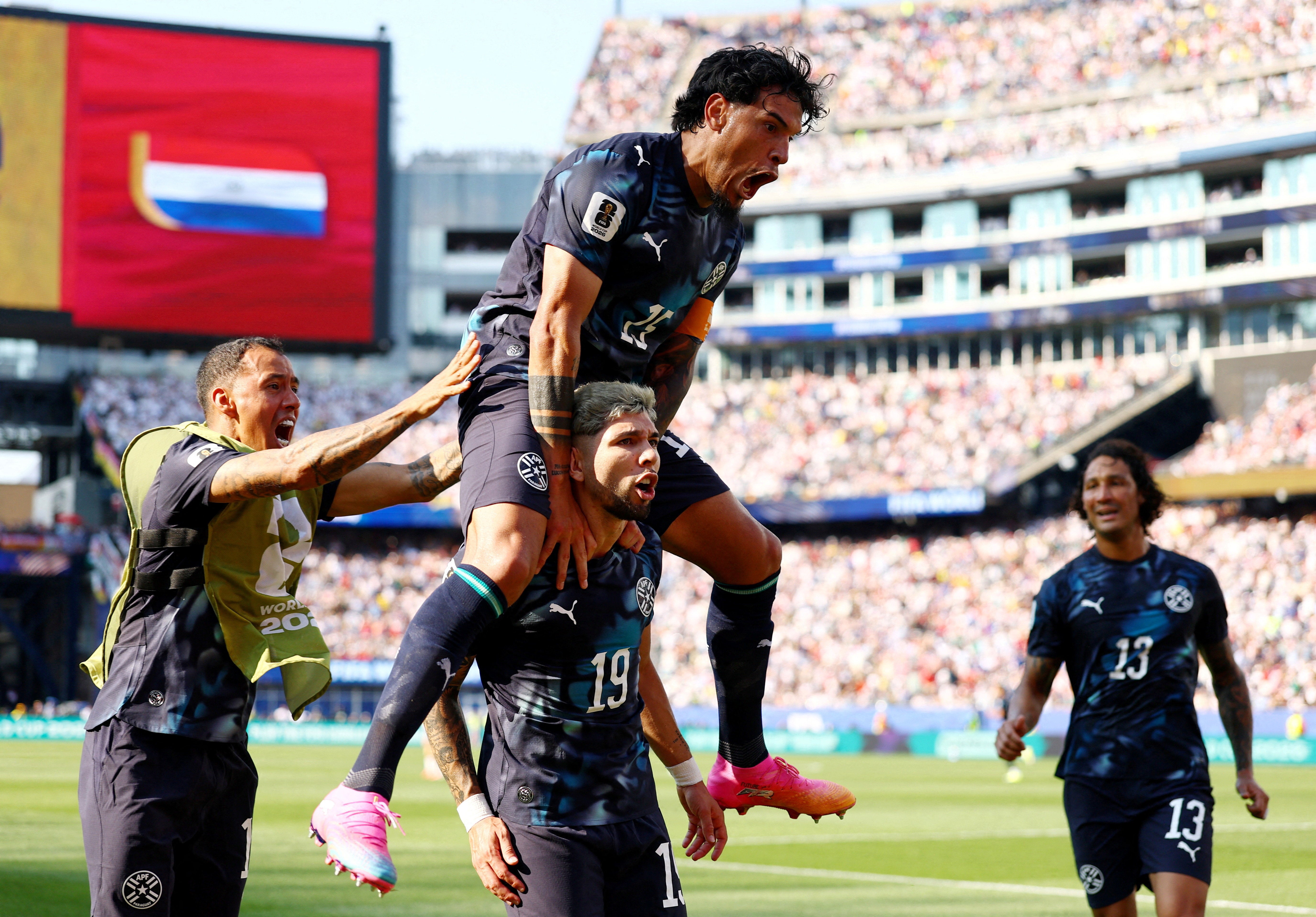 Paraguay's Julio Enciso celebrates scoring their first goal with Gustavo Gomez