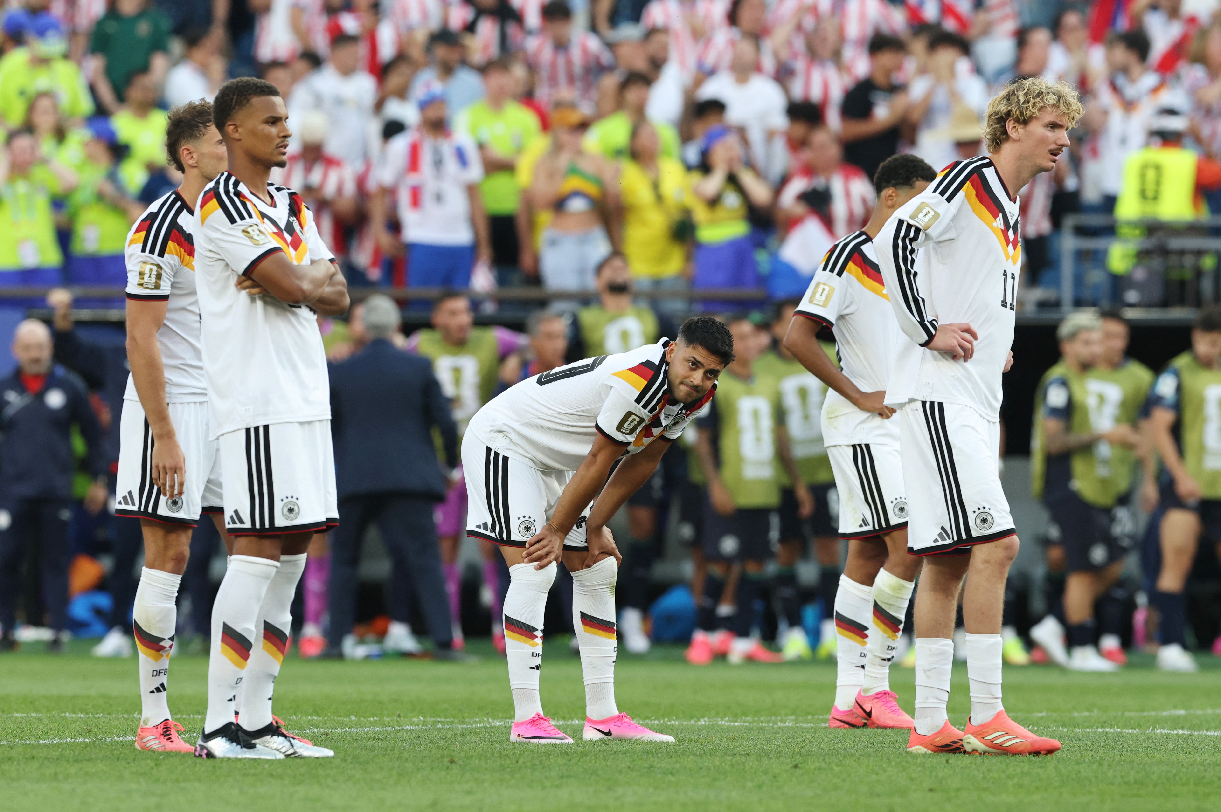 Germany's Nick Woltemade, Malick Thiaw and Nadiem Amiri react