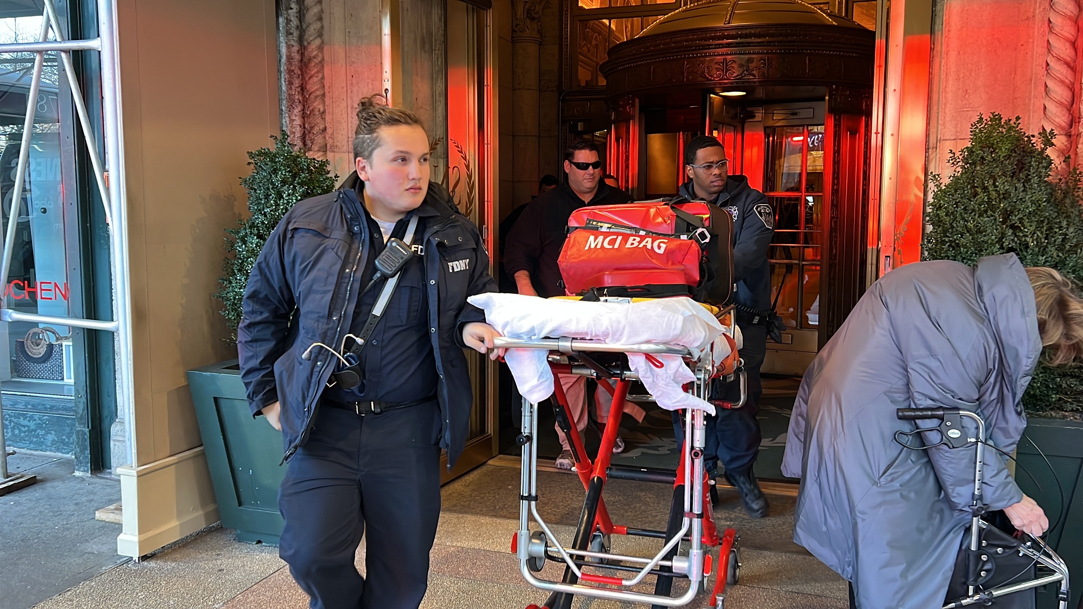 New York Fire Department emergency personnel walk an empty gurney from the Sherry-Netherland Hotel where fire broke out in Chinese tycoon Guo Wengui's penthouse apartment in the Upper East Side of New York city on 15 March 2023