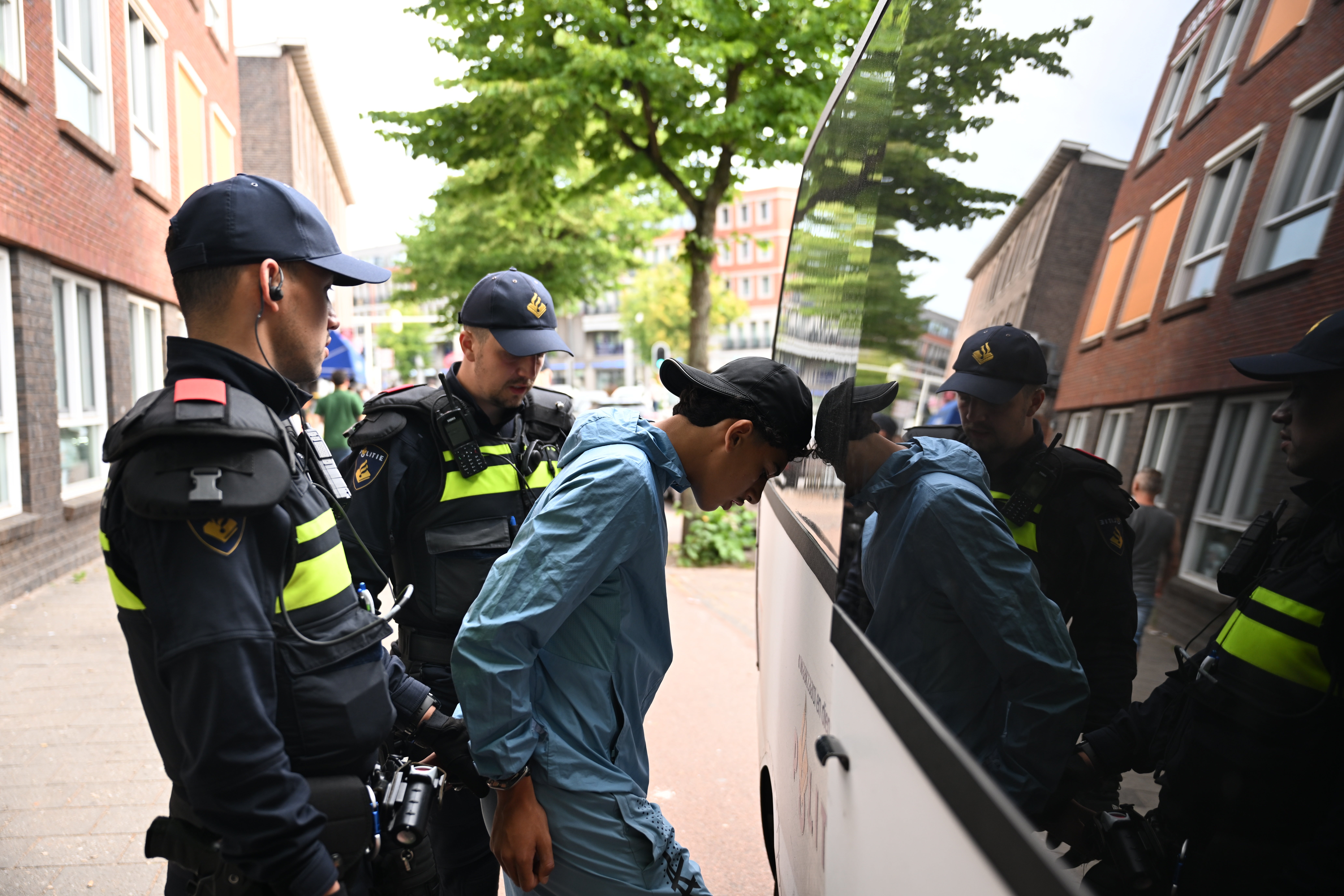 A fan is taken away by police