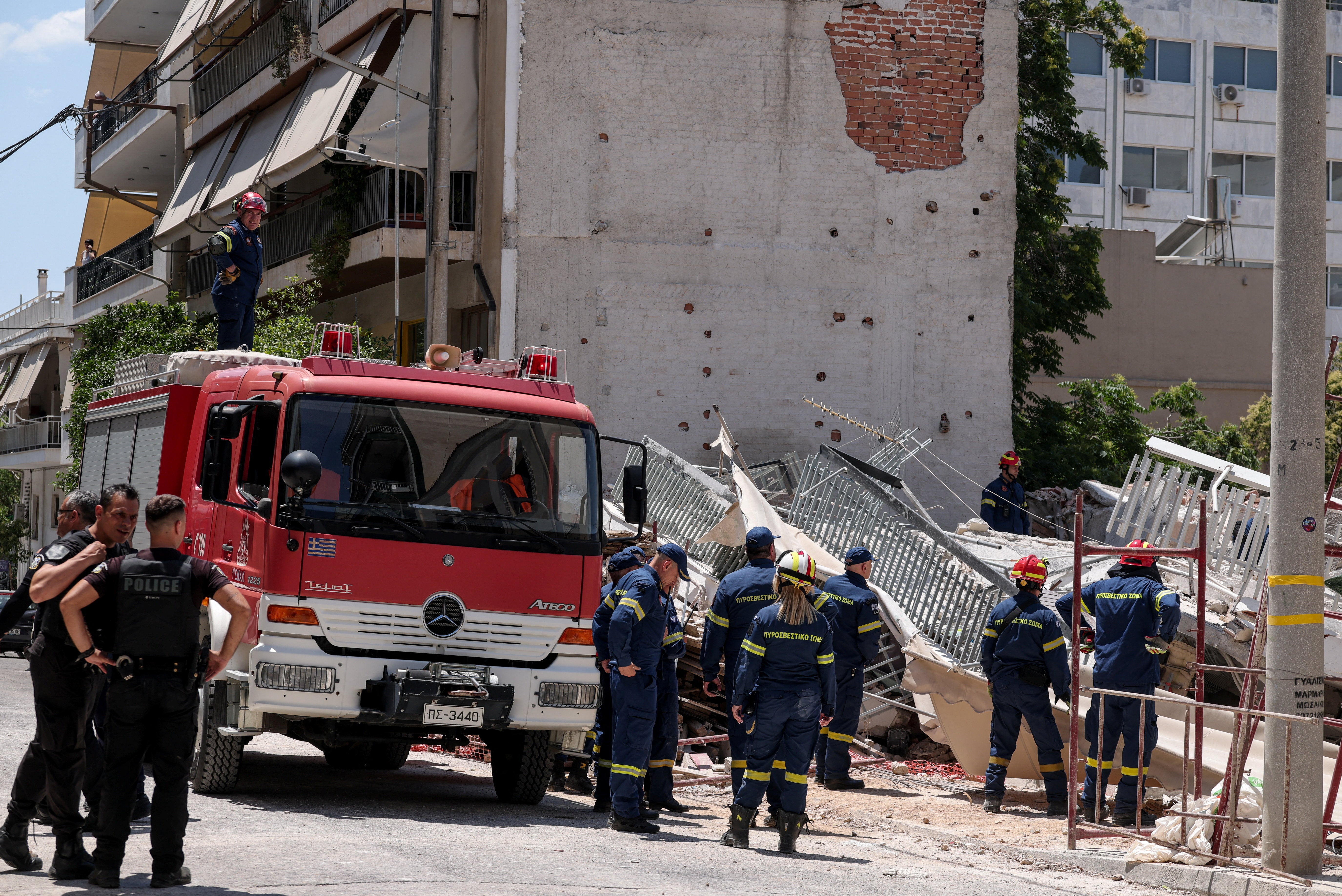 Emergency personnel work at the site of a building collapse in the Petralona neighbourhood of Athens