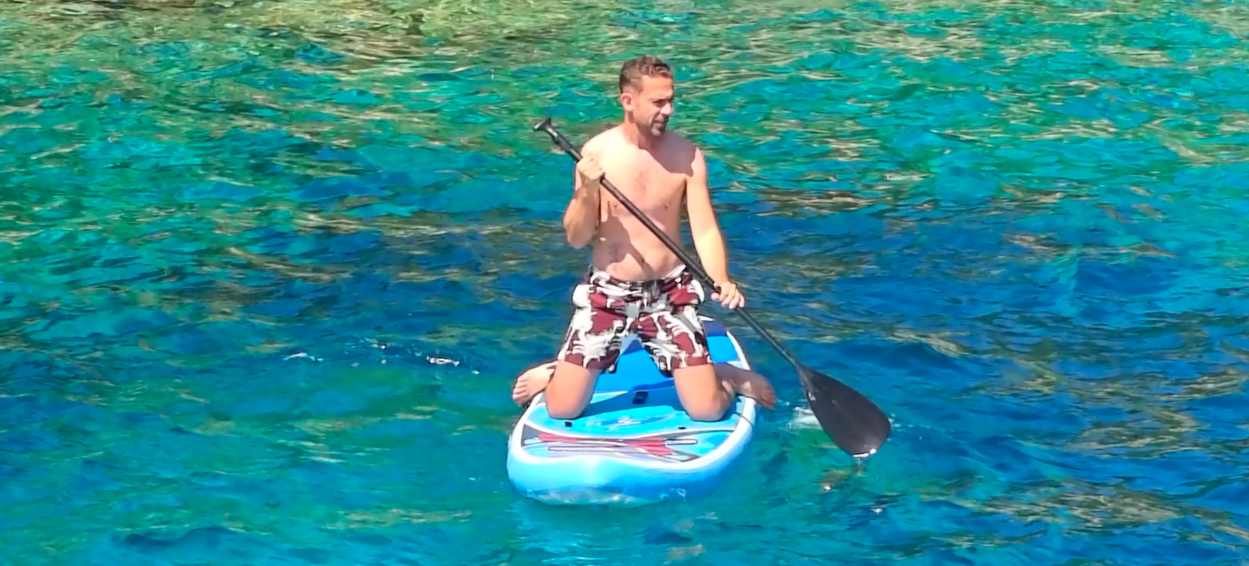 Marc Shoffman tries paddleboarding during a regular swim stop