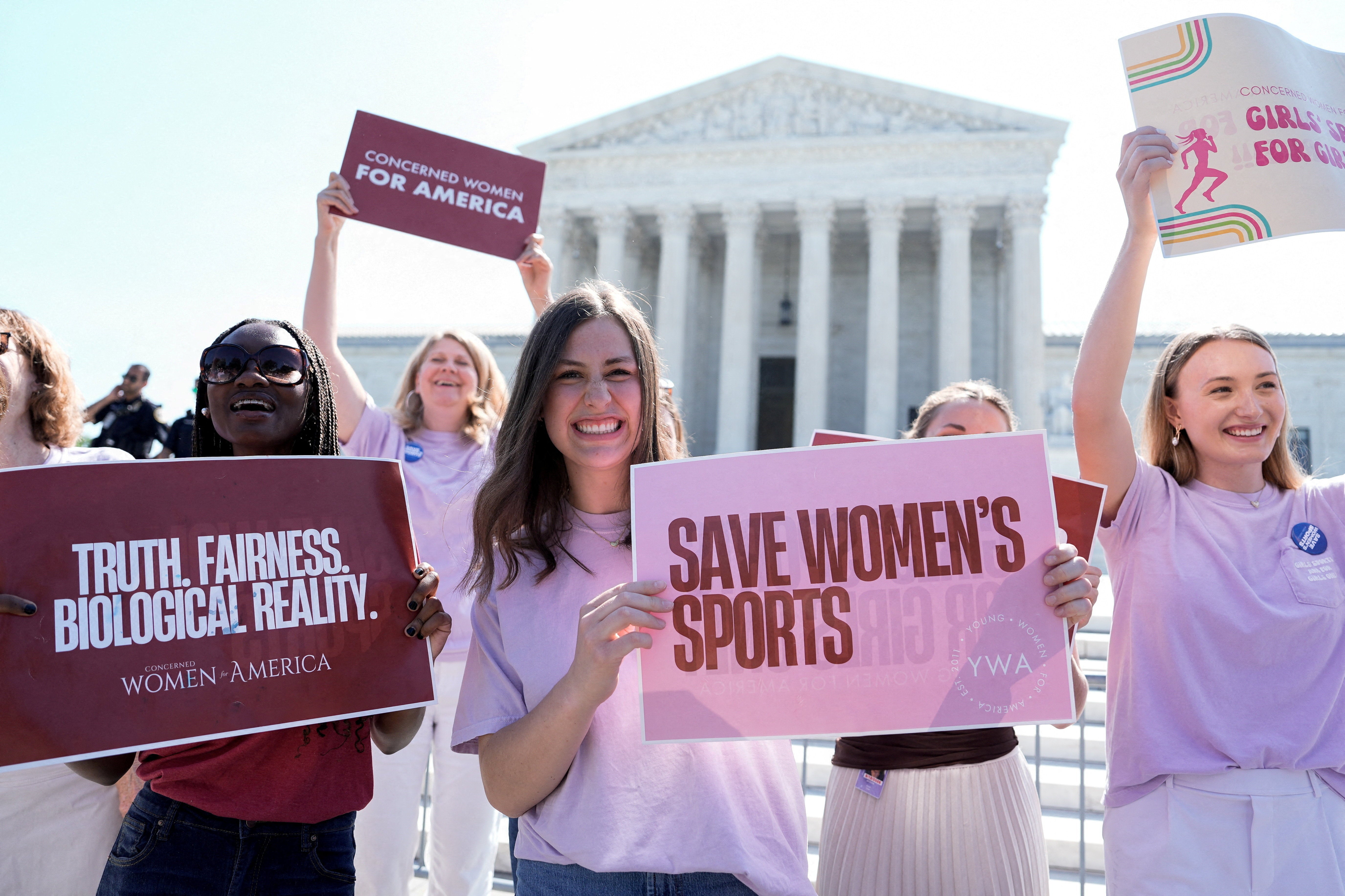 Activists who support states banning transgender women and girls from competing on teams celebrate after the Supreme Court decision Tuesday (Reuters)