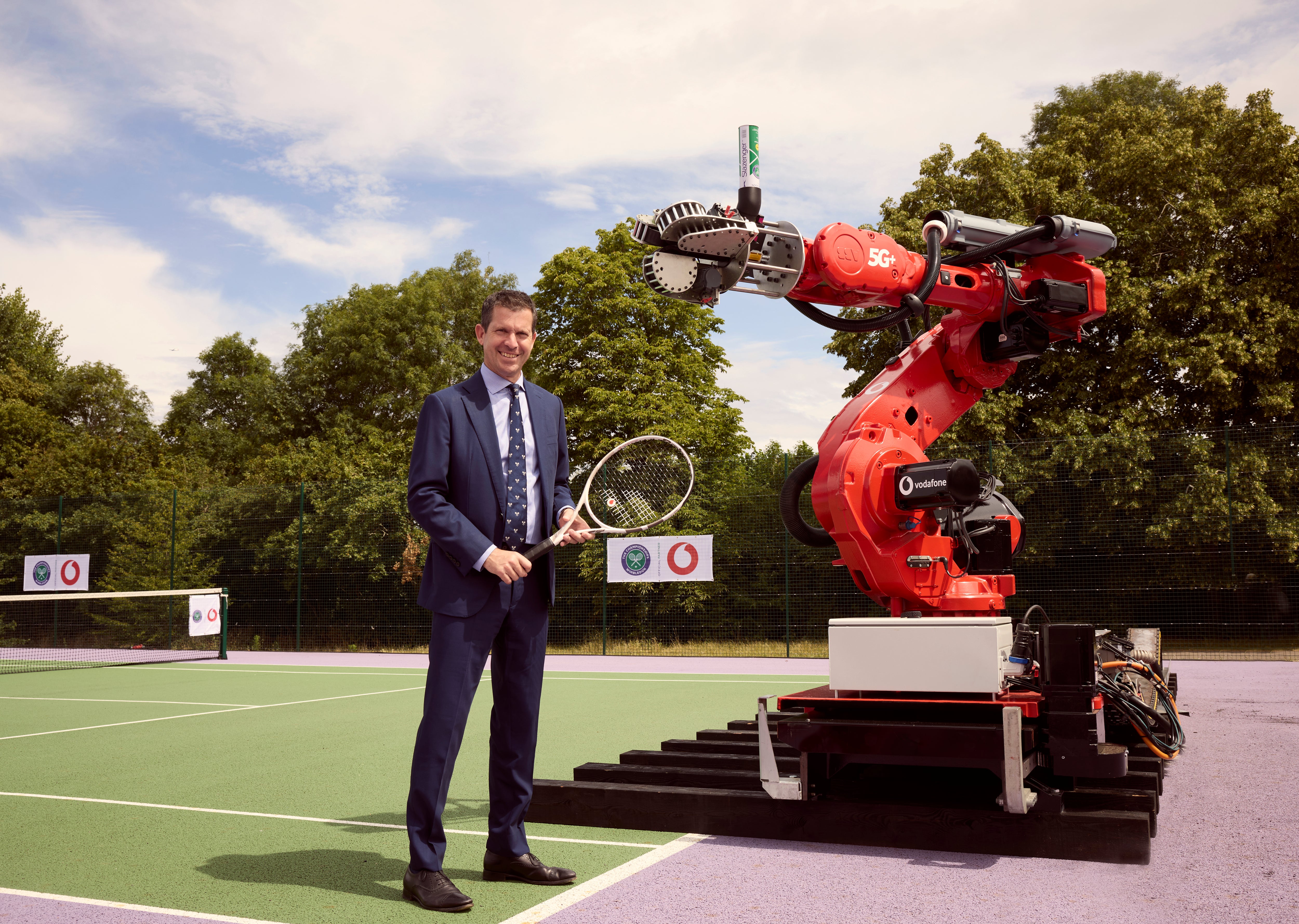 Tim Henman with Vodafone’s robotic serving arm (Vodafone/PA)