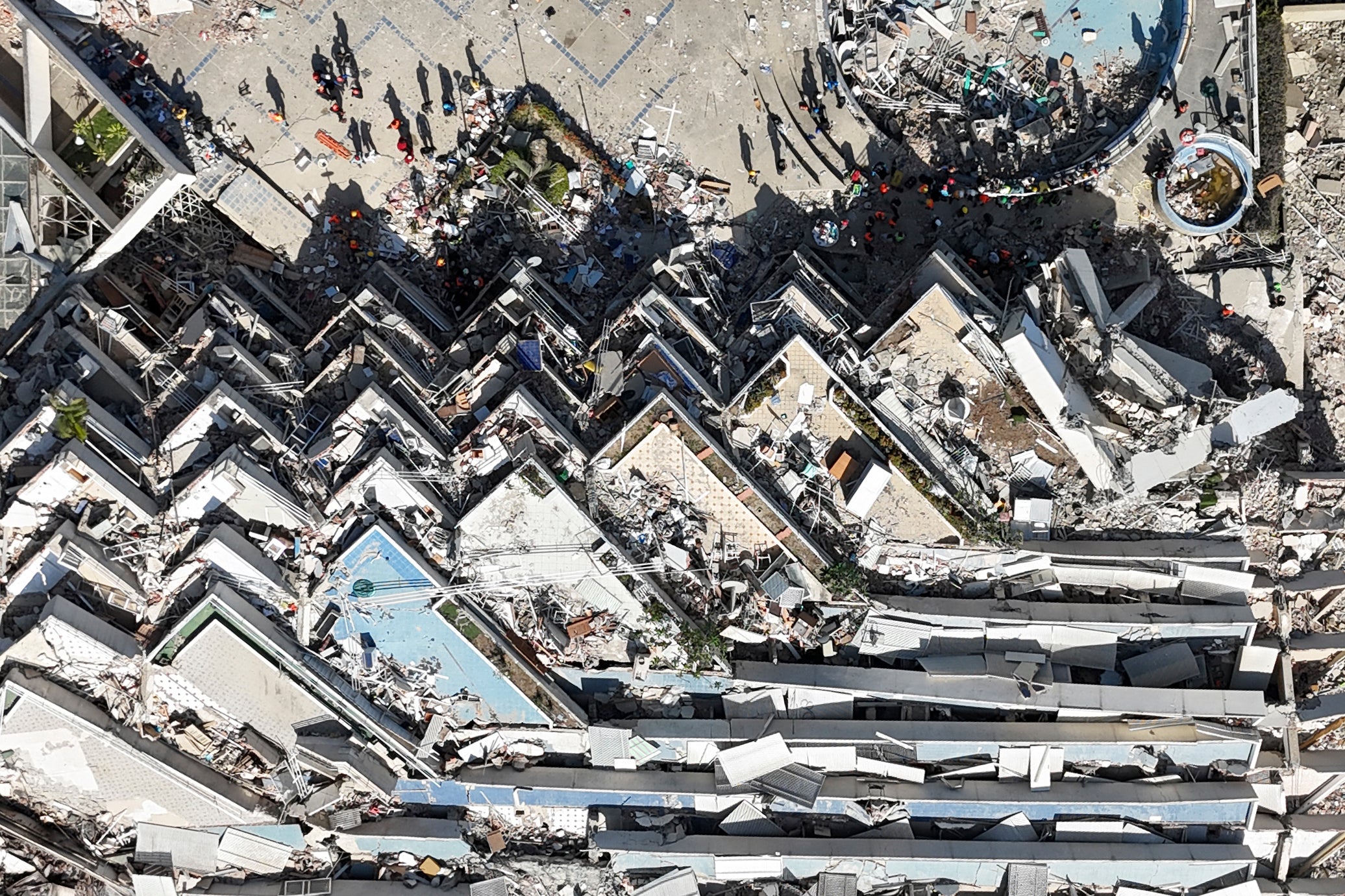 This aerial view shows a collapsed multi-storey building and surrounding debris near a coastal road following the June 24 twin earthquakes in Caraballeda, La Guaira State, Venezuela, on June 29, 2026.