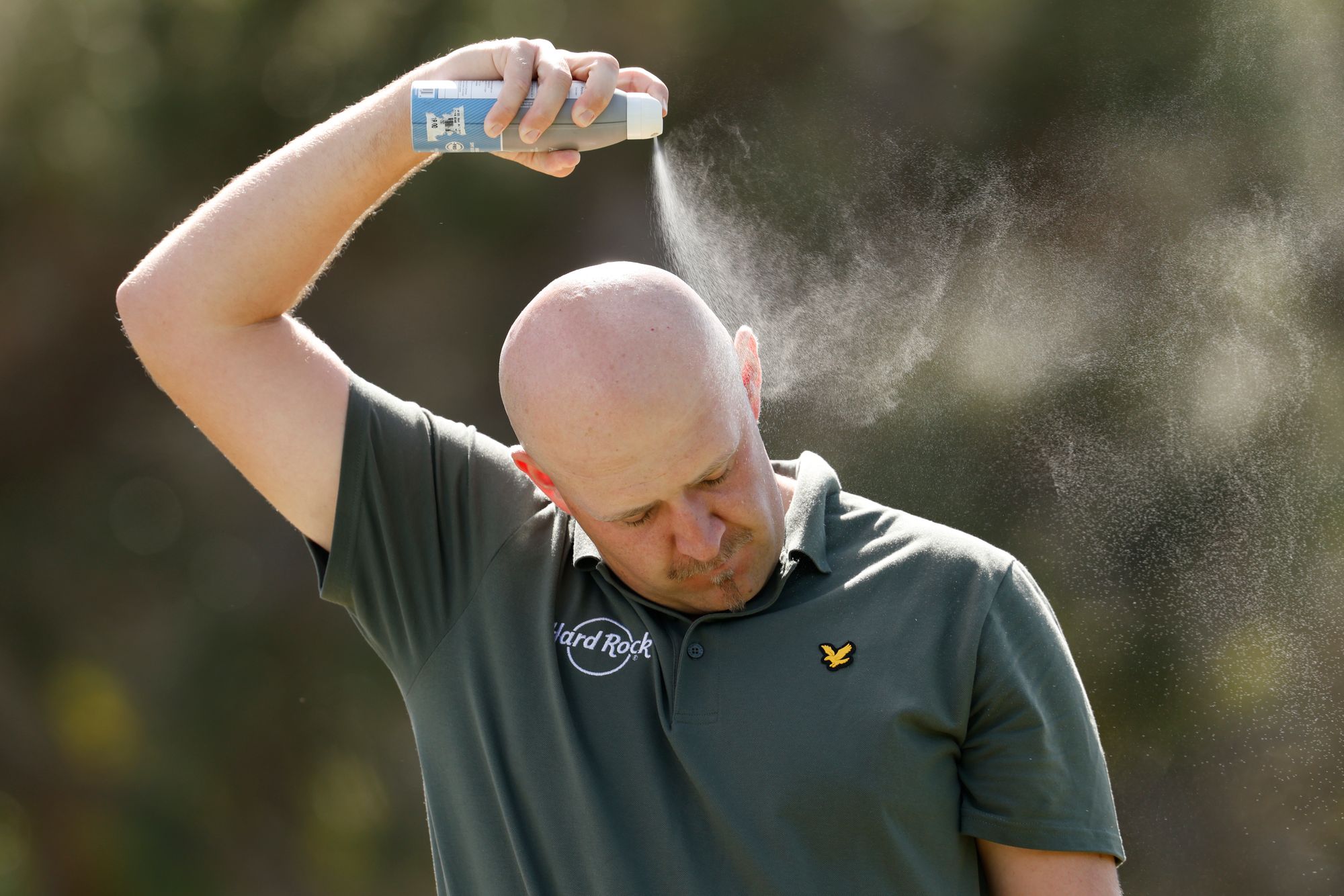 A golfer applies sunscreen at the Sony Open in Honolulu, Hawaii, earlier this year. Frequently applying sunscreen is critical to ensuring you don’t get burned