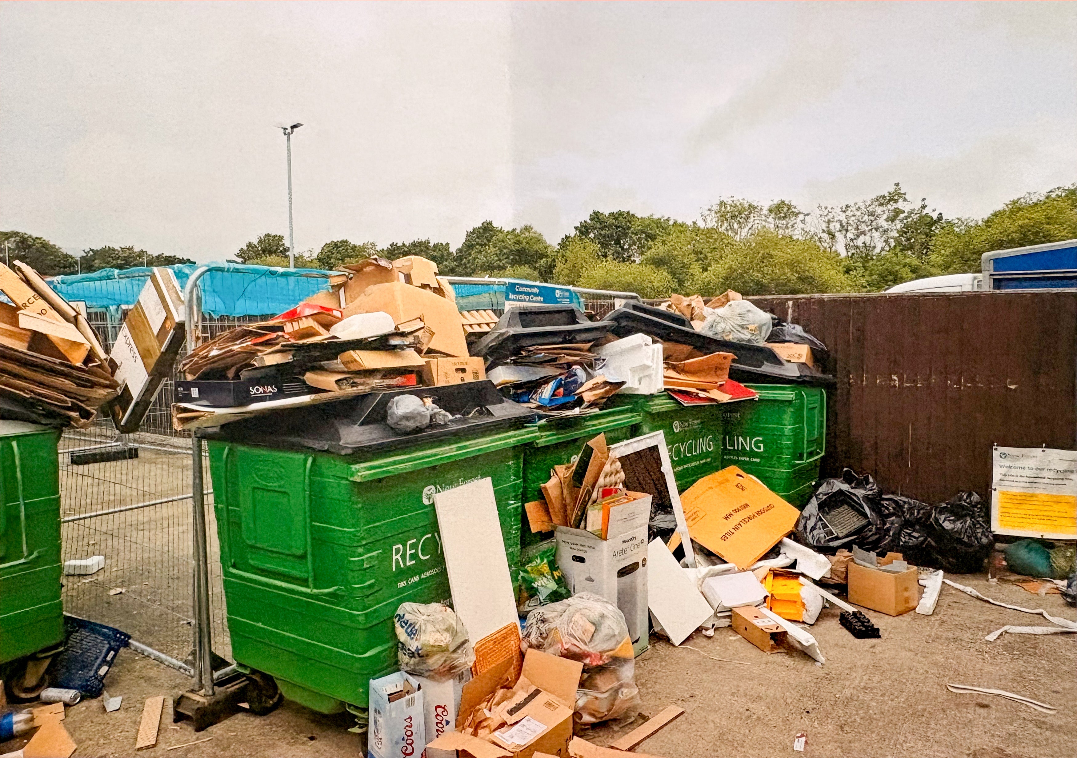The bin was full to overflowing, with rubbish around it