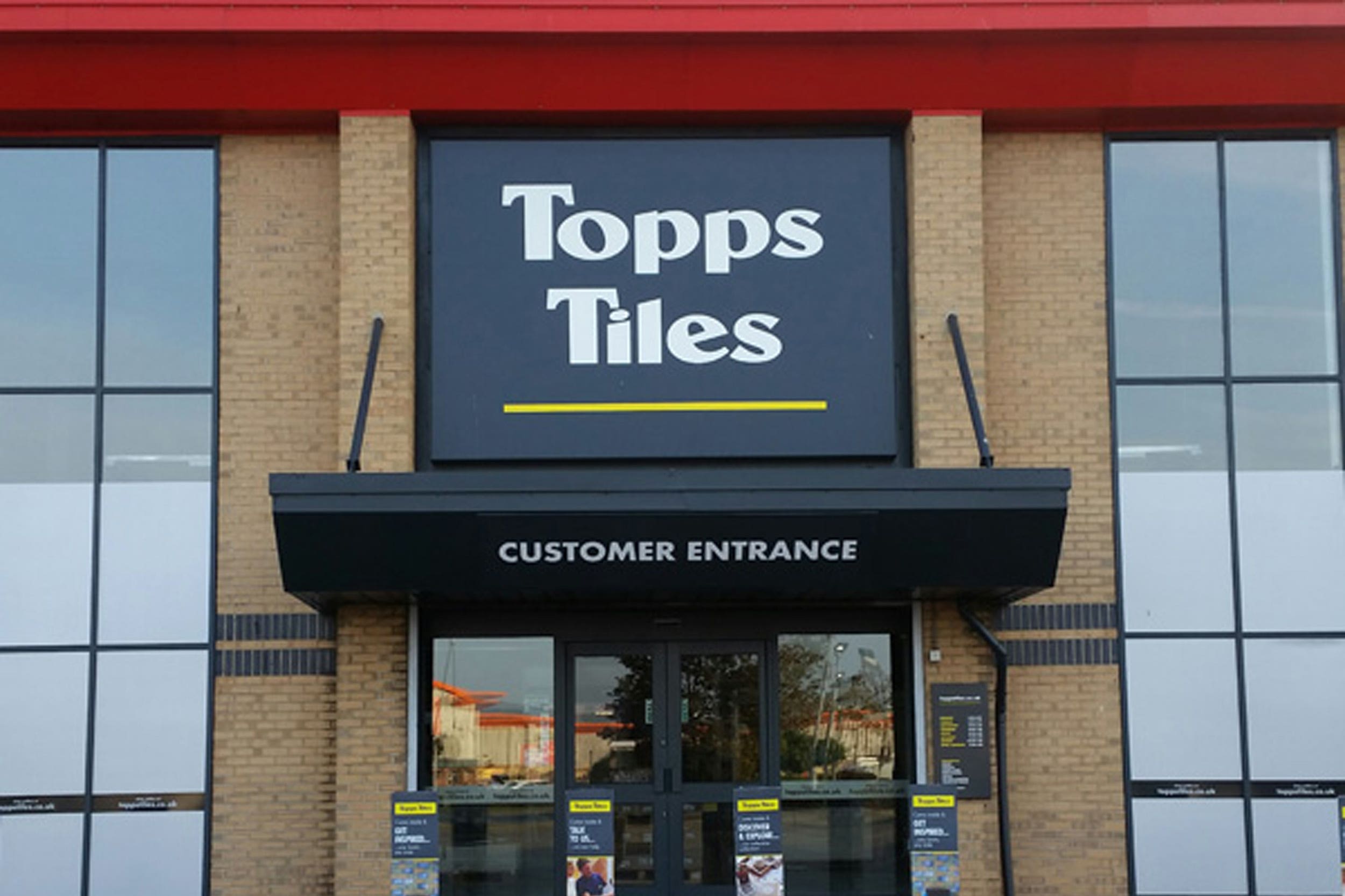 Topps Tiles said soaring temperatures led to traders pausing work