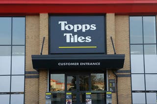 Topps Tiles said soaring temperatures led to traders pausing work