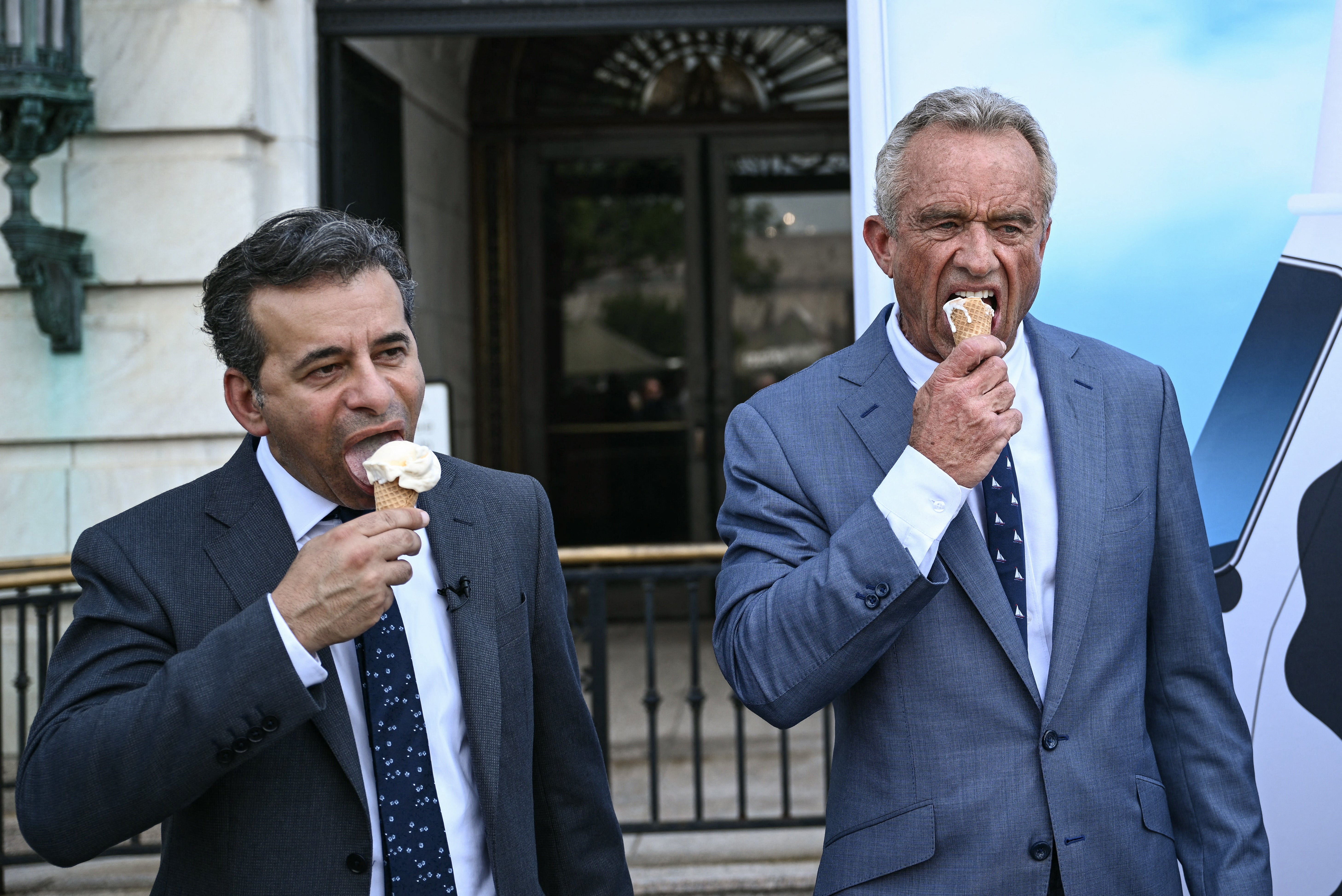 Food and Drug Administration Commissioner (FDA) Martin Makary and Secretary of Health and Human Services Robert F. Kennedy Jr., eat ice cream at the end of a news conference at the USDA headquarters building