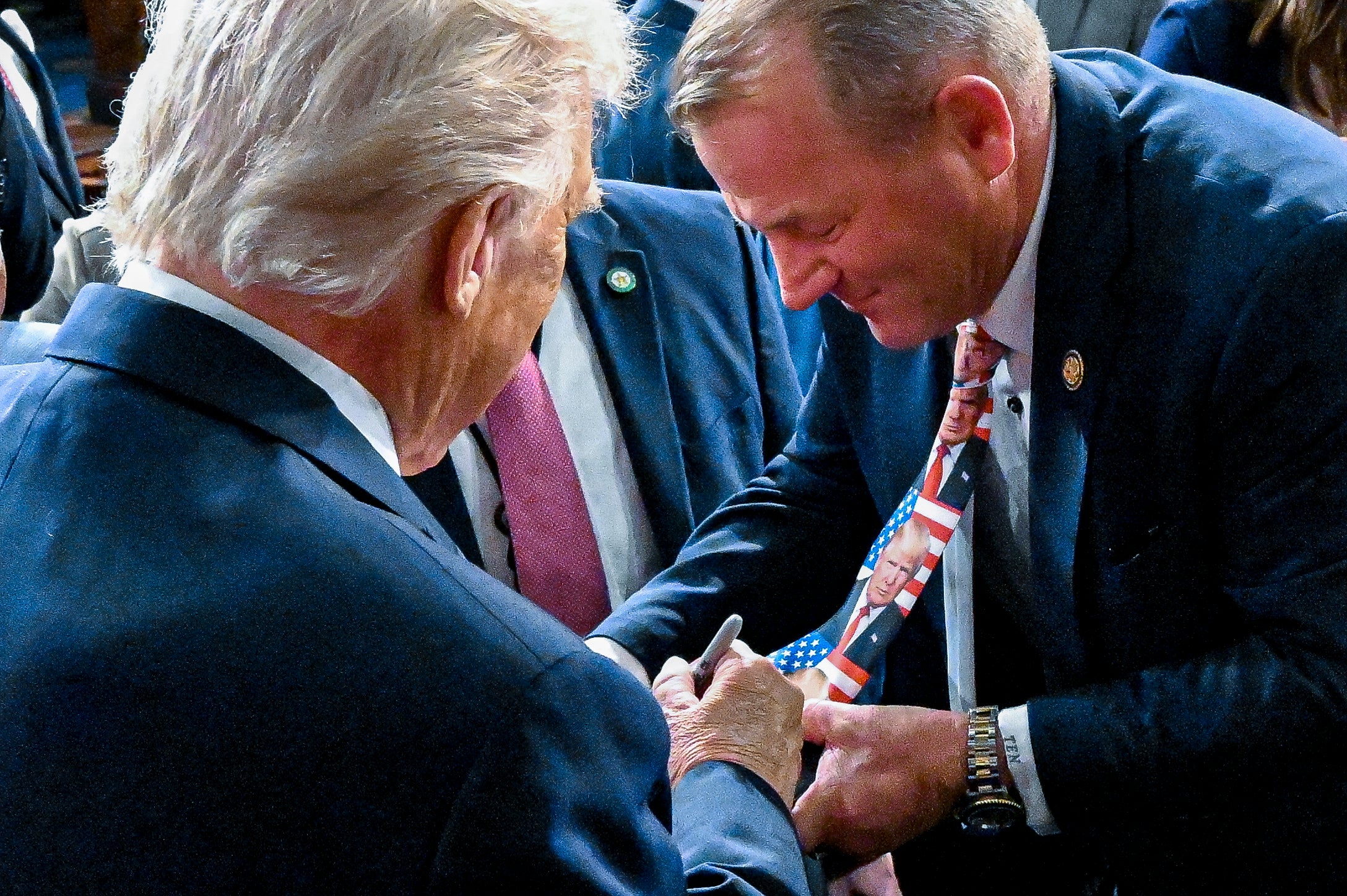 During the State of the Union address in February, Nehls wore a tie emblazoned with Trump’s face — and asked the president to sign it