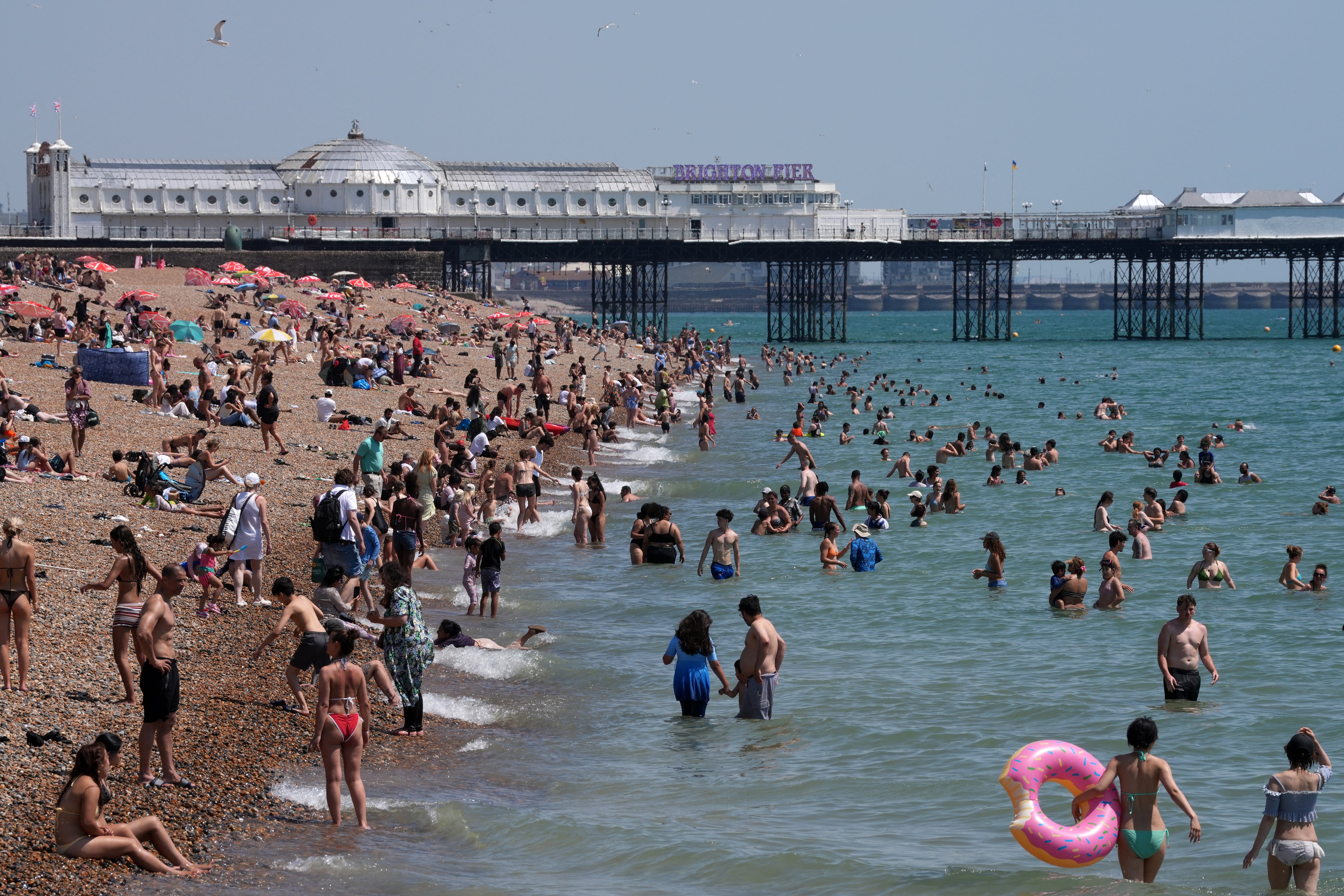People attempt to cool down in the sea in Brighton during June's record-breaking heatwave, June 24 (AFP/Getty)