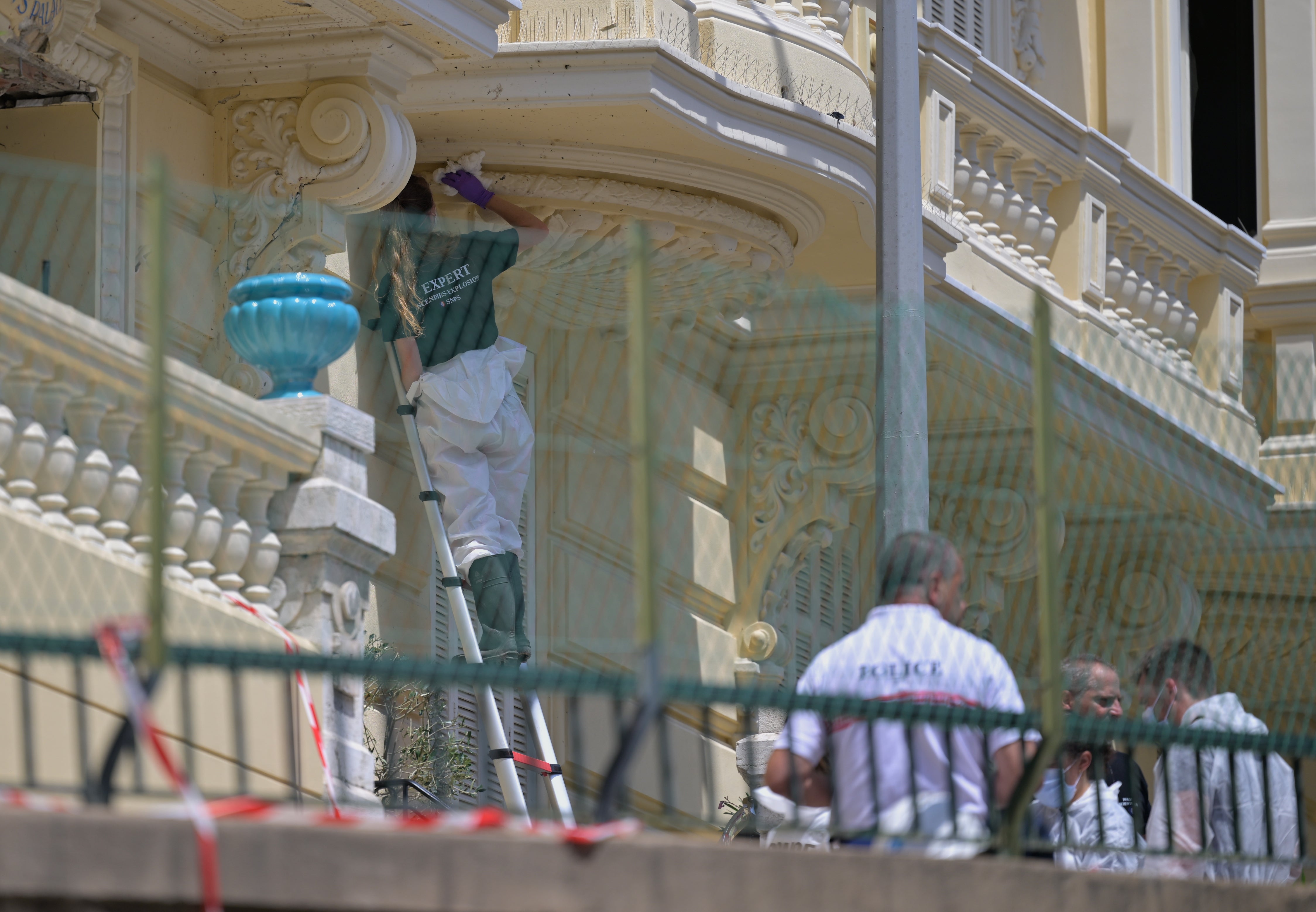 An investigator examines the scene at the residential building
