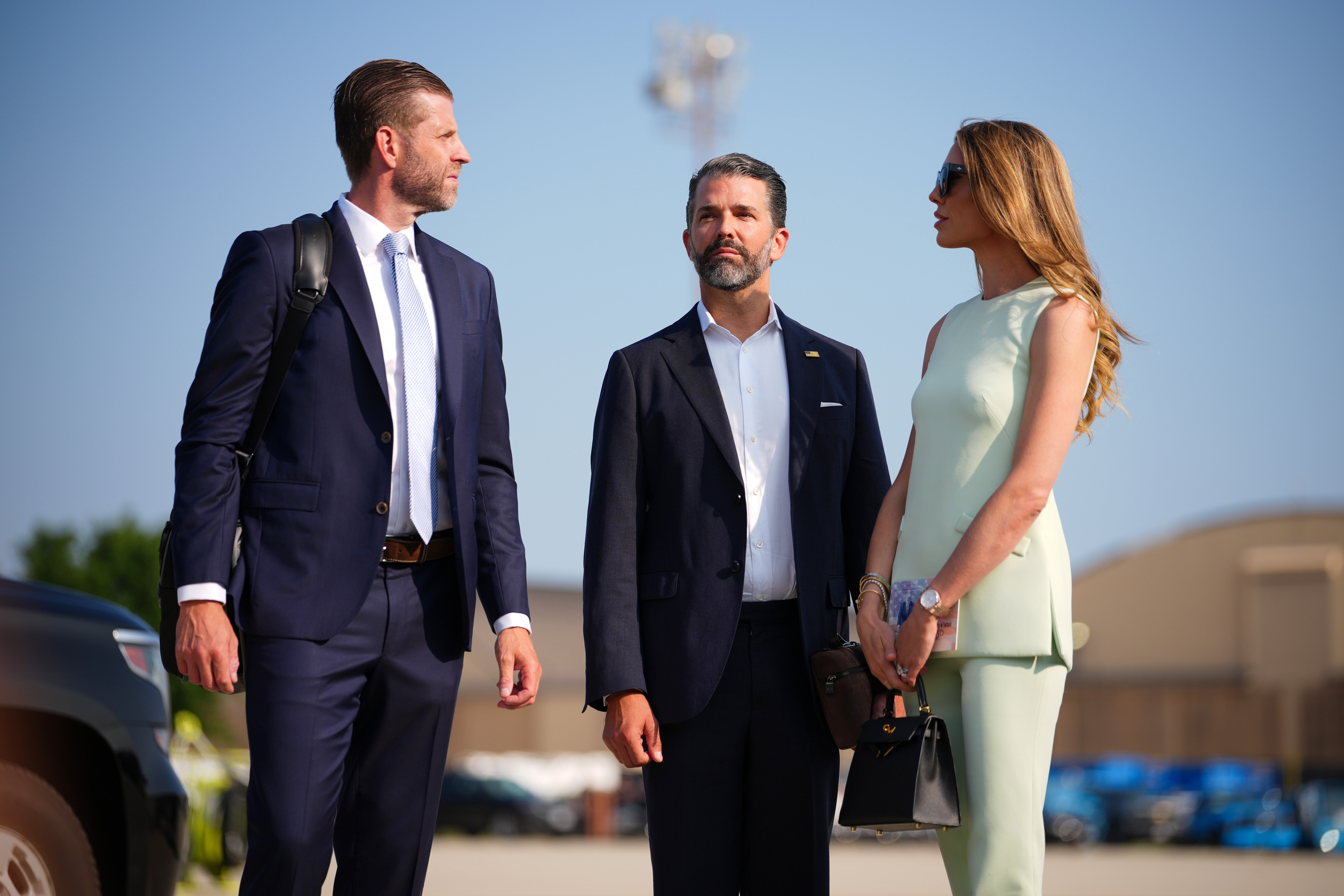 Eric Trump, Donald Trump Jr. and Bettina Anderson prepare to board Air Force One with President Donald Trump en route to North Dakota to attend the Theodore Roosevelt Presidential Library dedication. (Getty)