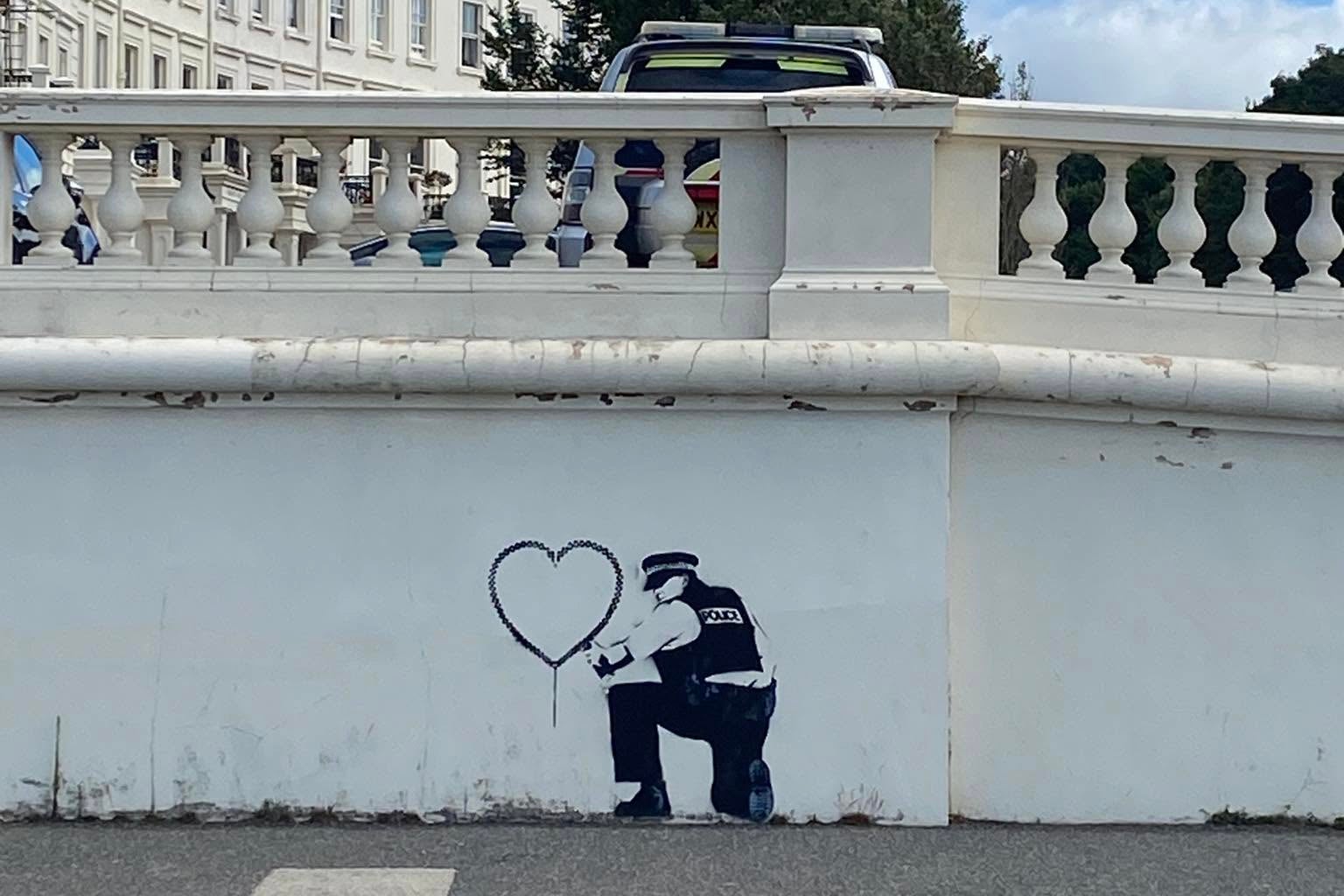 A police car can be seen near the alleged Banksy mural on the Hove seafront on Wednesday (Chris Roche)