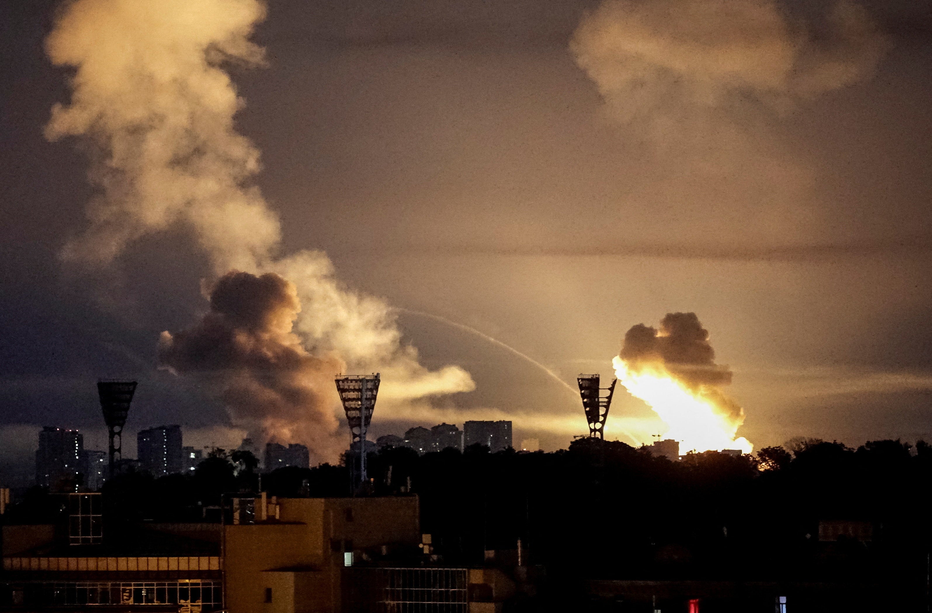 An explosion lights up the sky over the city during a Russian missile and drone strike in Kyiv