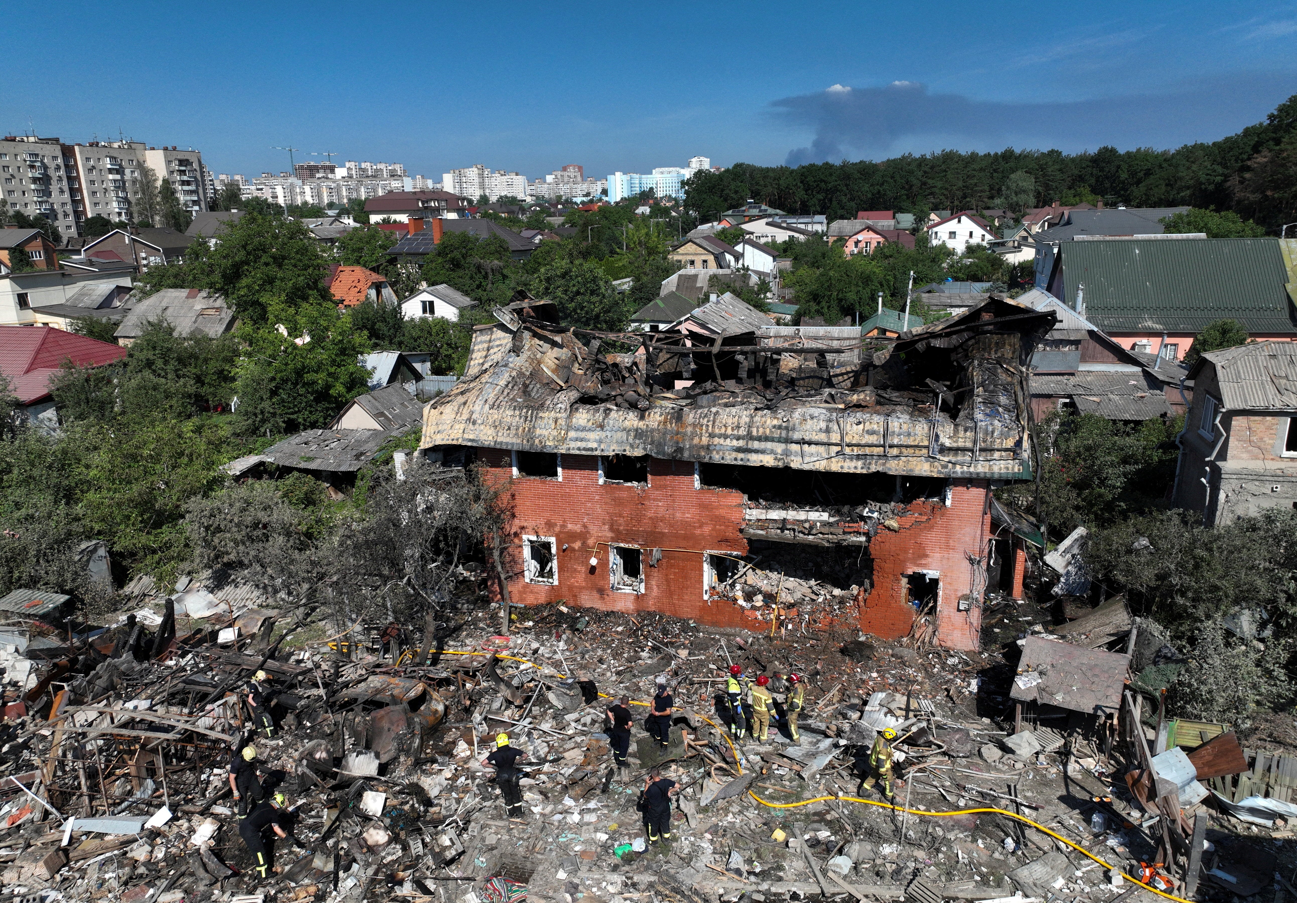 A drone view shows rescuers working at the site of a private house damaged during overnight Russian missile and drone strikes