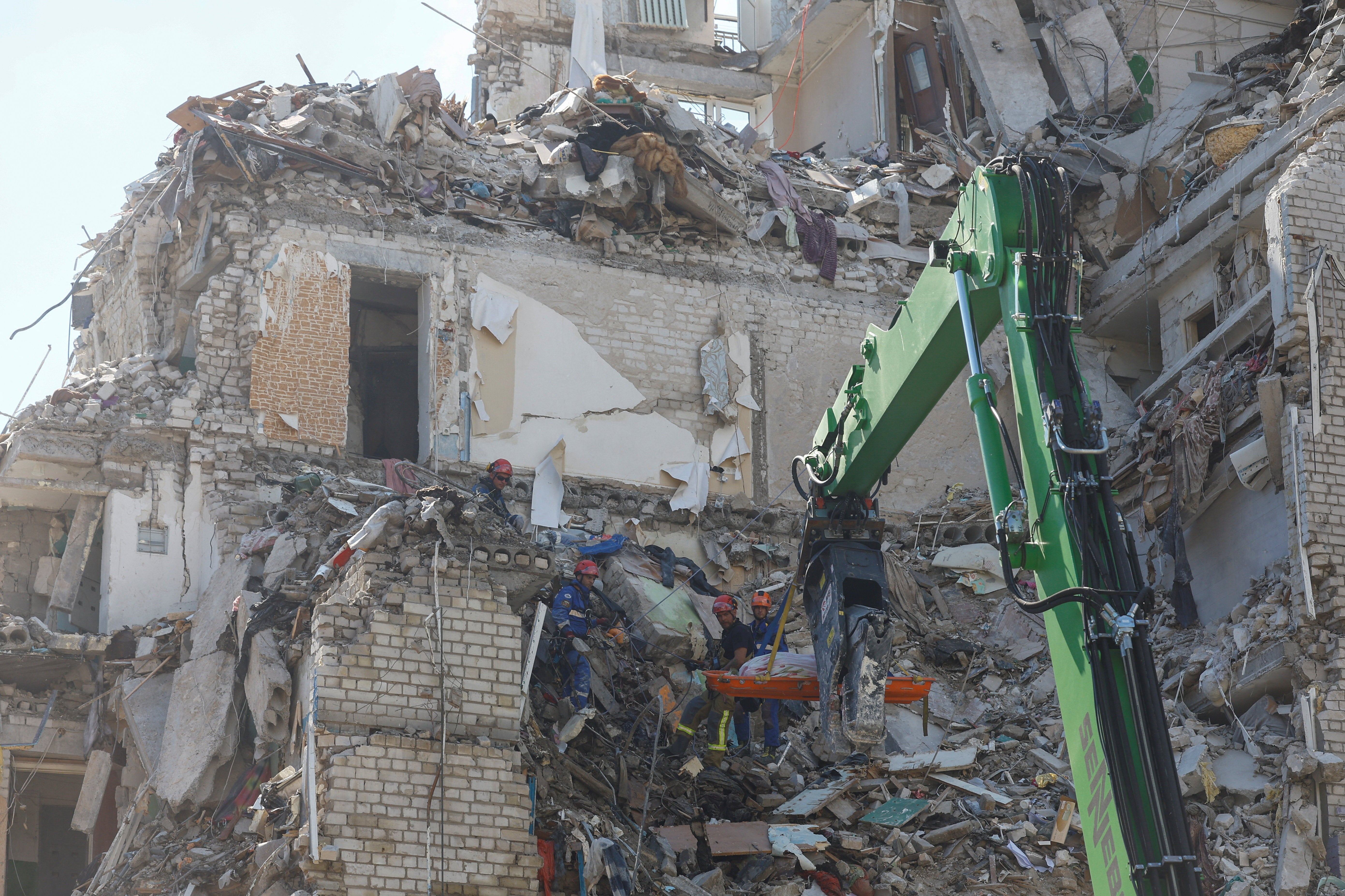 Rescuers use a crane to carry the body of a killed person found under debris of an apartment building damaged during overnight Russian missile and drone strikes (Reuters)