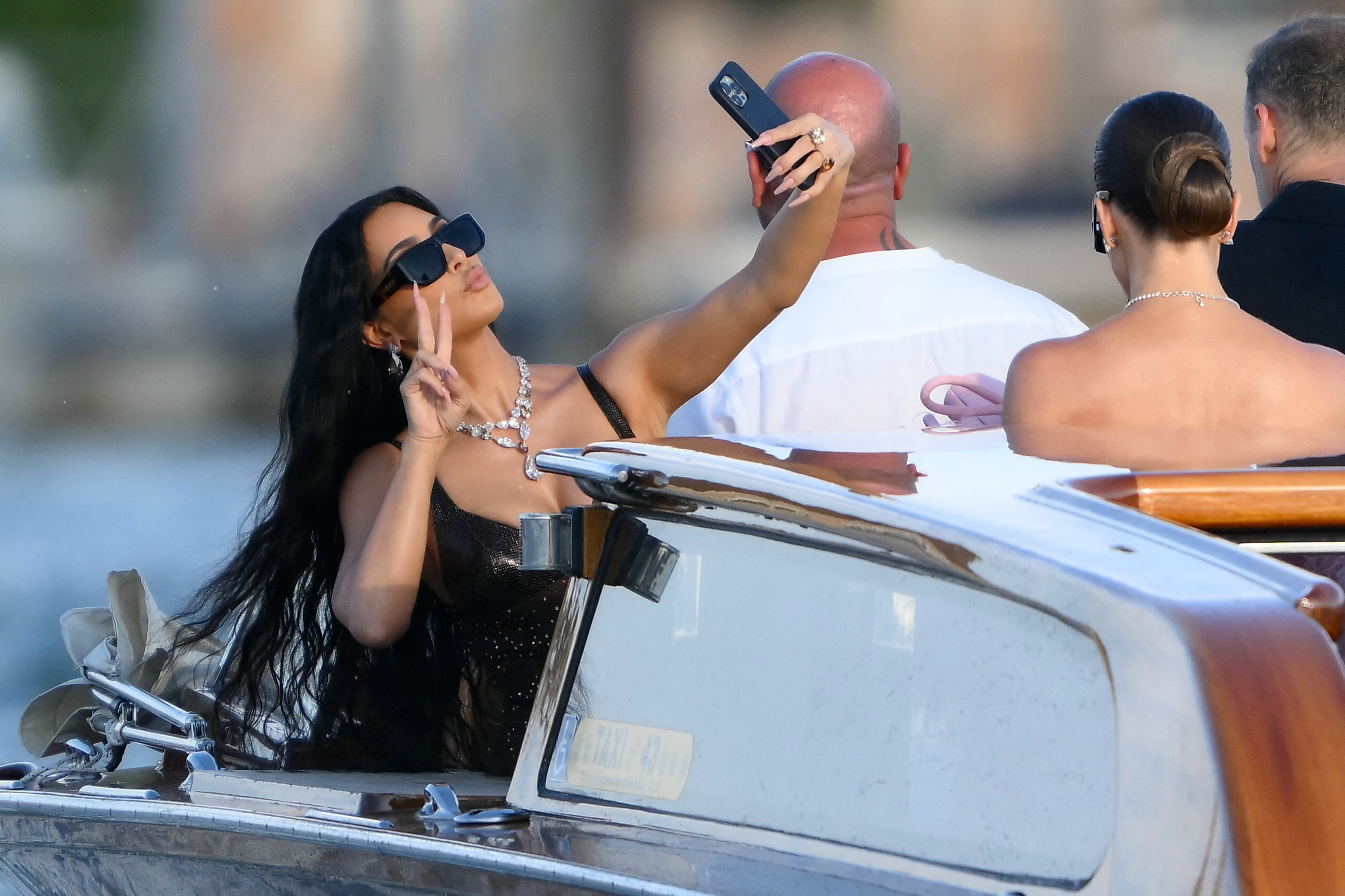 Following in her sister's footsteps? Kim Kardashian taking a selfie at Jeff Bezos' wedding