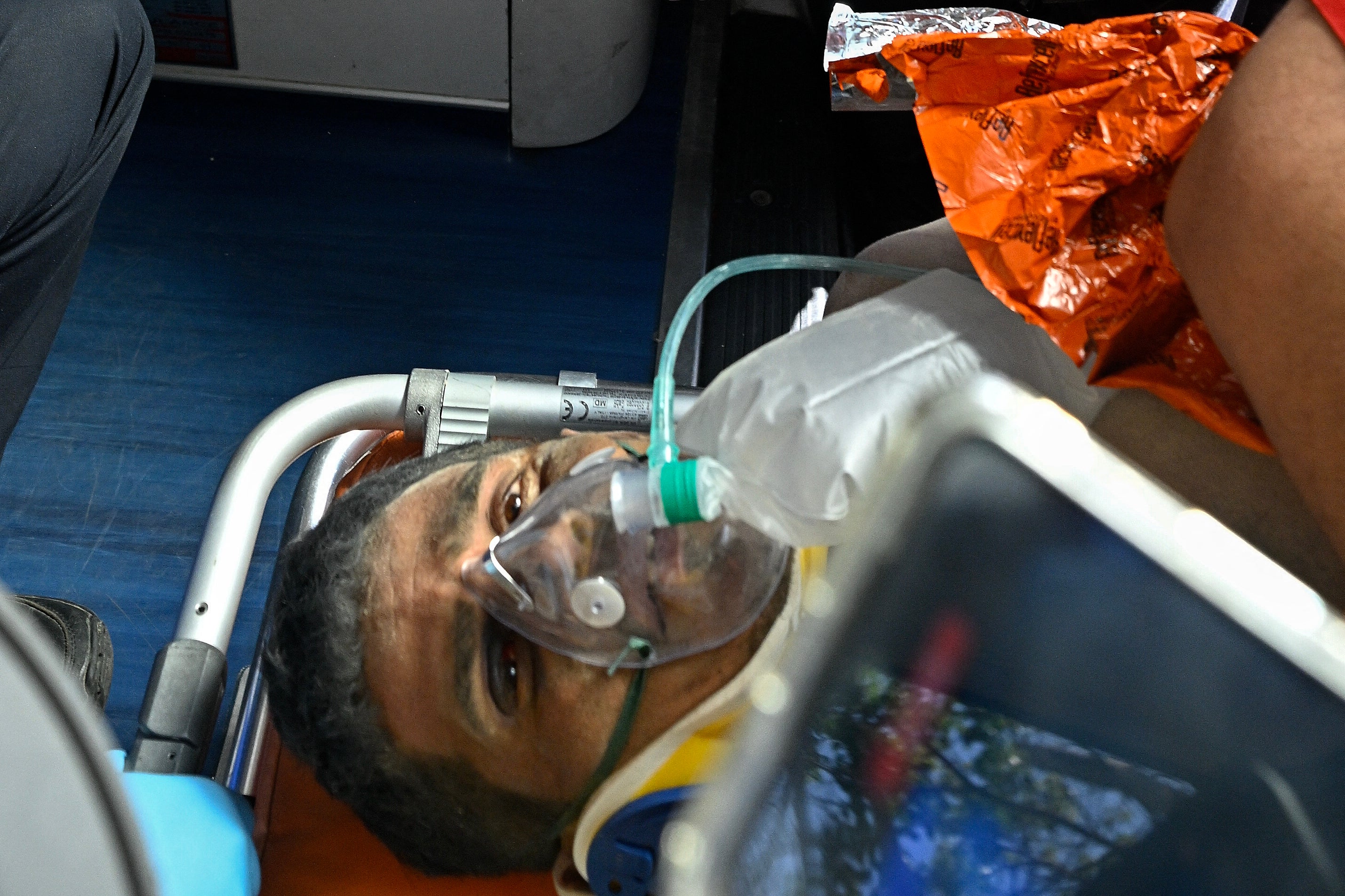 Hernan Gil, a survivor of Venezuela's twin earthquakes, is rushed into an ambulance by members of international rescue teams in Catia La Mar, La Guaira State, Venezuela on July 2, 2026