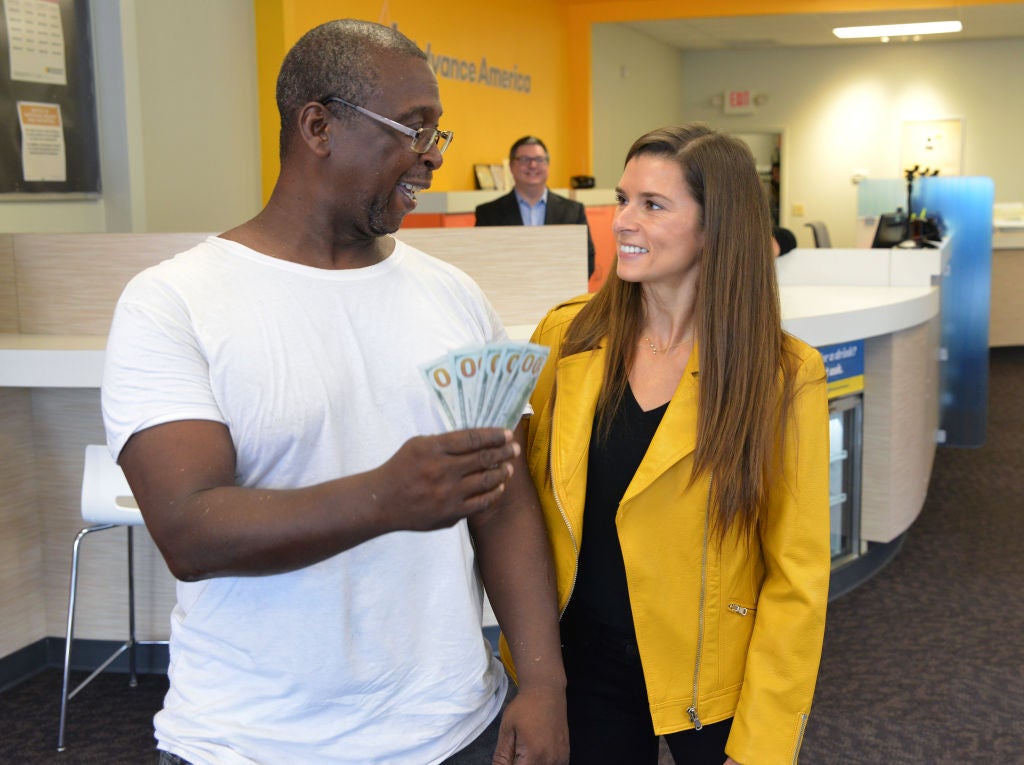Professional Race Car Driver and Advance America Brand Ambassador Danica Patrick surprises customer Ernest Colston by paying his bill in celebration of Advance America's 20th Anniversary Sweepstakes on August 15, 2017, in Spartanburg, South Carolina. Experts typically recommend against borrowing money from payday lenders, as fees are high for the small amount of money that's borrowed
