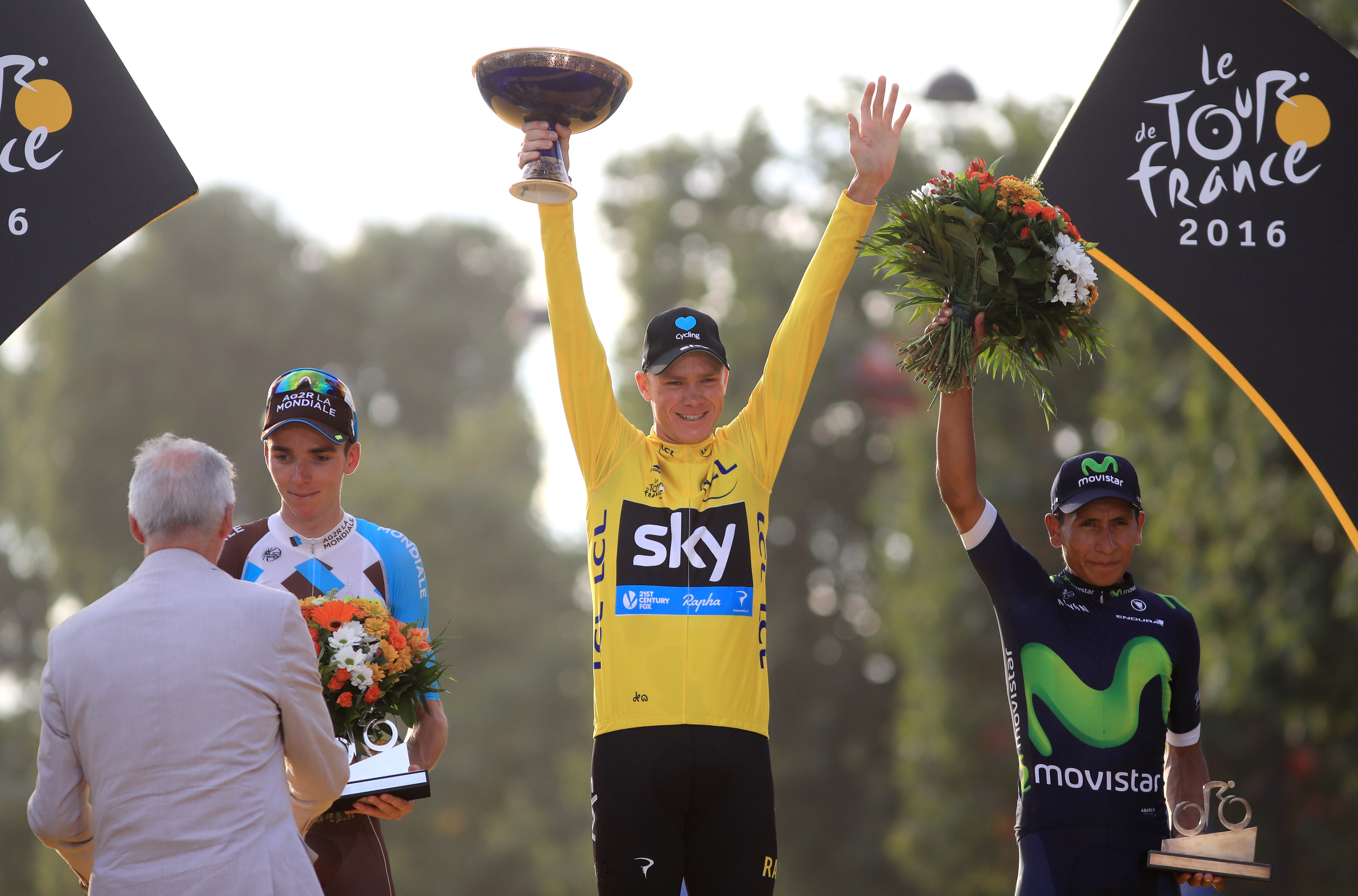 Chris Froome celebrates as he collects the yellow jersey for winning the Tour De France in 2016 (John Walton/PA)